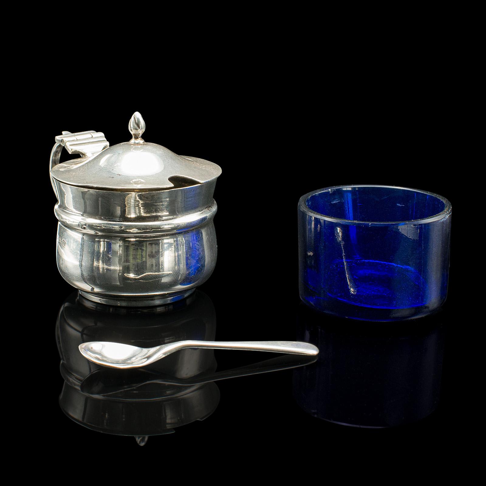 
This is an antique mustard pot. An English, silver and glass table condiment server, hallmarked in Birmingham, 1919.

Charming small serving pot, with a fine appearance
Displays a desirable aged patina and in good order
Silver presents bright