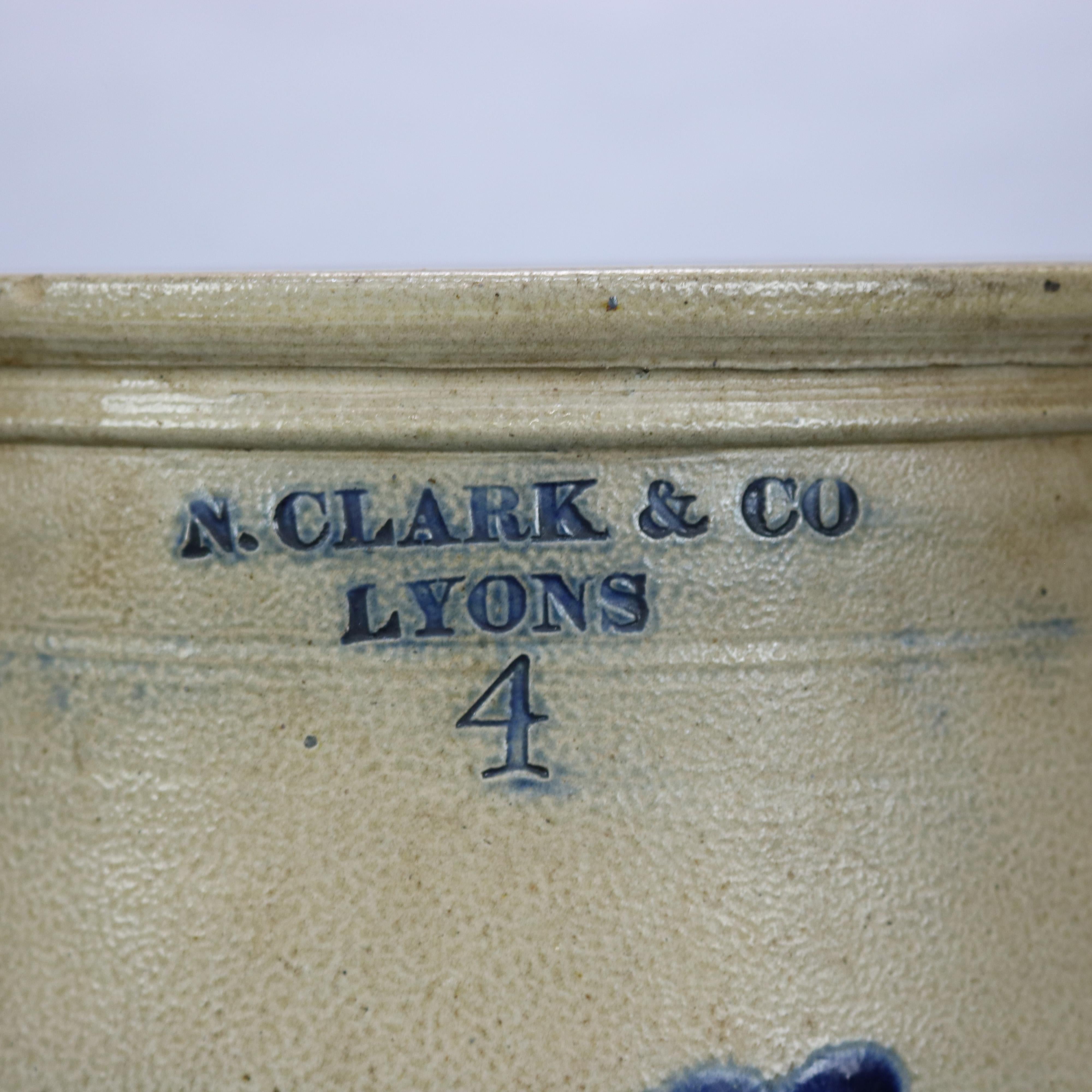 An antique stoneware crock by Clark & Co, Lyons offers four gallon double handle salt glazed vessel with blue foliate decoration and maker stamped as photographed, 19th century

Measures: 12.75