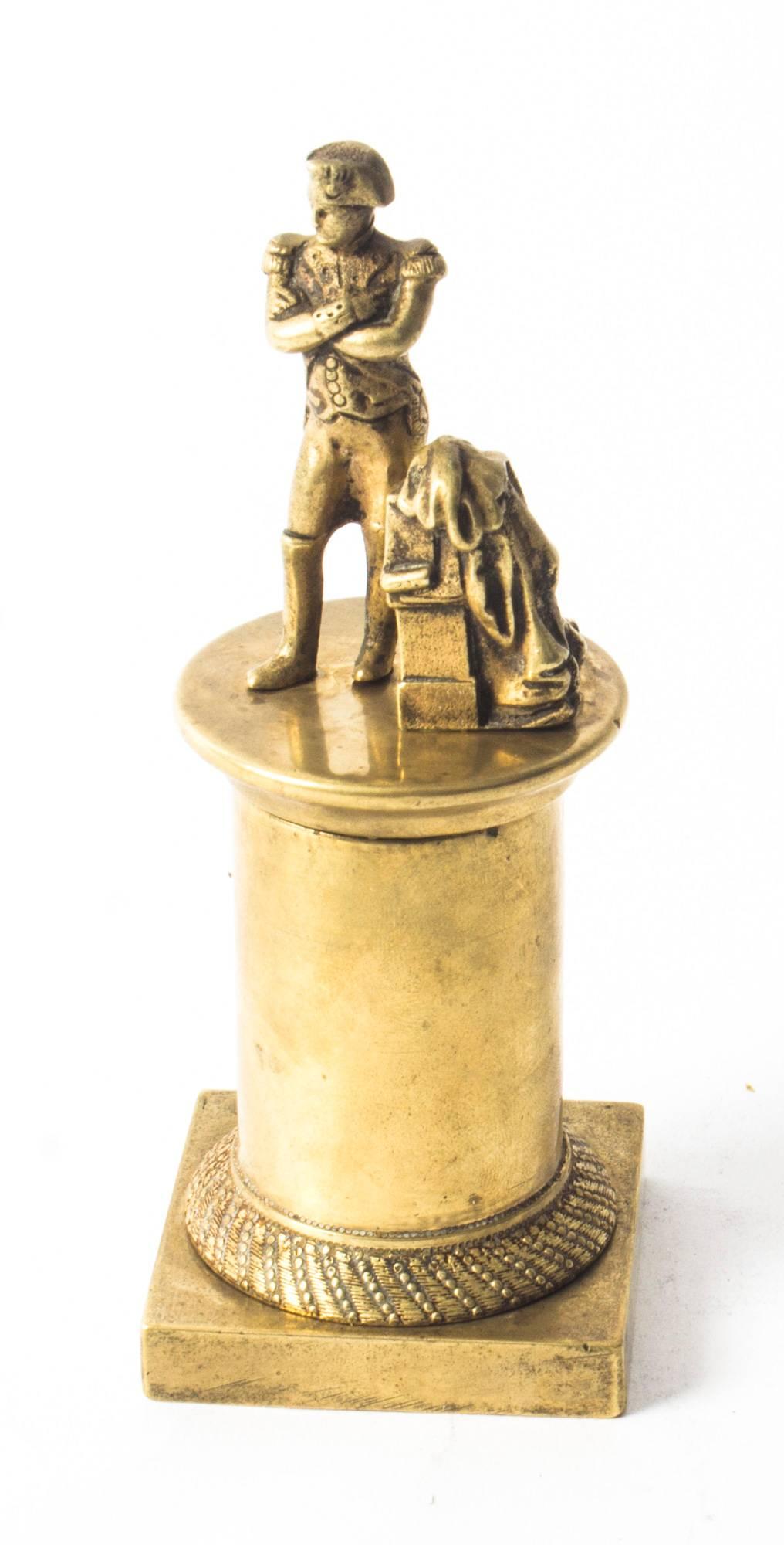 This is a charming atom polished bronze desk model sculpture of Napoleon Bonaparte, circa 1830 in date.
 
It features Napoleon in uniform mounted on a beautiful cylindrical columnar pedestal with a decorative engine turned socle raised on a square
