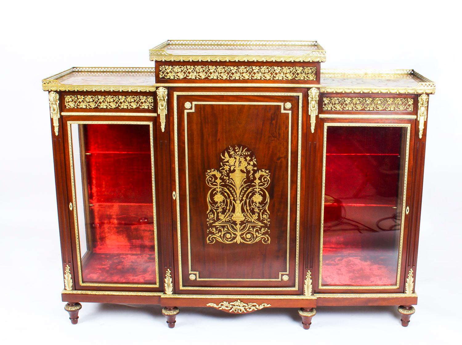 This is an absolutely stunning exhibition quality antique Napoleon III, flame mahogany and cut brass inlaid Boulle breakfront credenza, circa 1860 in date.

This striking credenza is profusely decorated with fabulous ormolu mounts and a striking