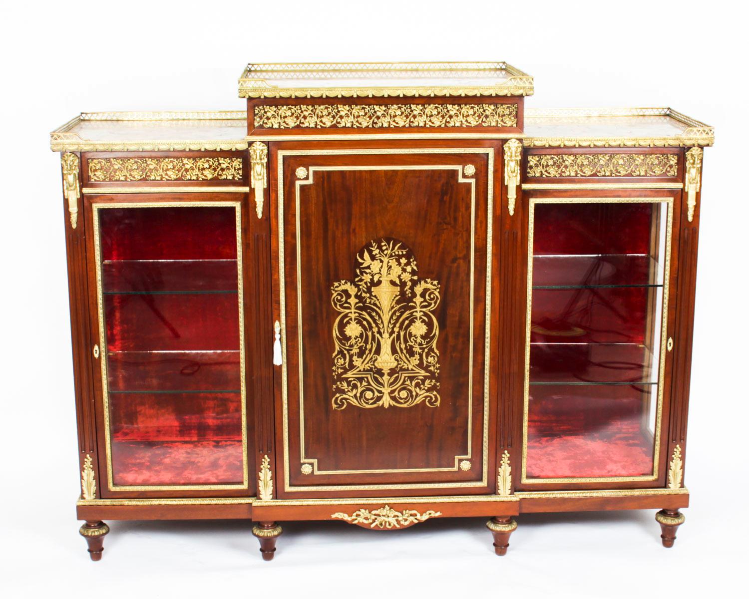 This is an absolutely exquisite exhibition quality antique Napoleon III, flame mahogany and cut brass inlaid Boulle breakfront credenza, circa 1860 in date.
This striking credenza is profusely decorated with fabulous ormolu mounts and a striking