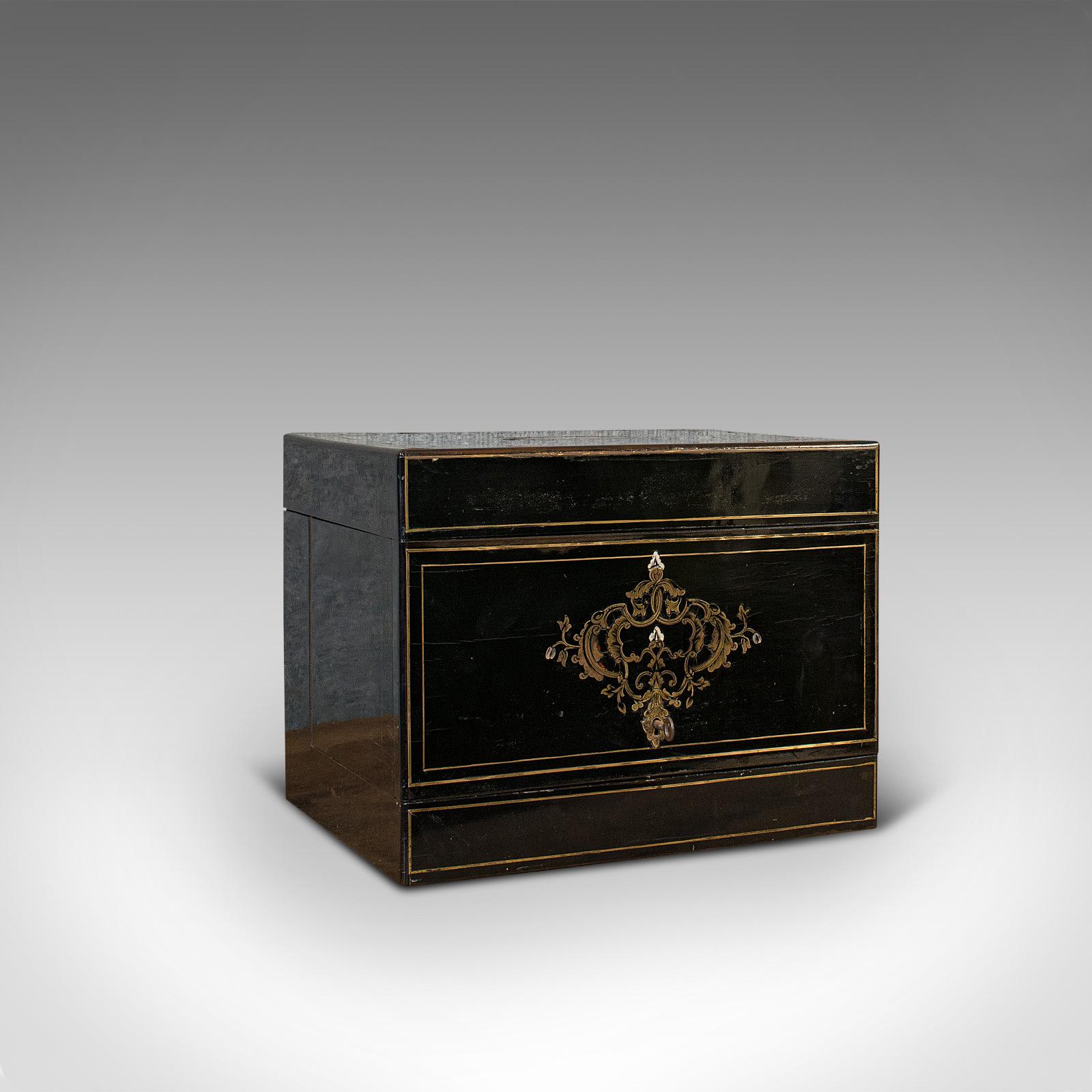 This is an antique Napoleon III liquor cellar. A French, ebonized rosewood liqueur box with fitted interior and cut glass decanters, dating to the early 19th century, circa 1830.

A classical French Cave à Liqueur
Displays a desirable aged