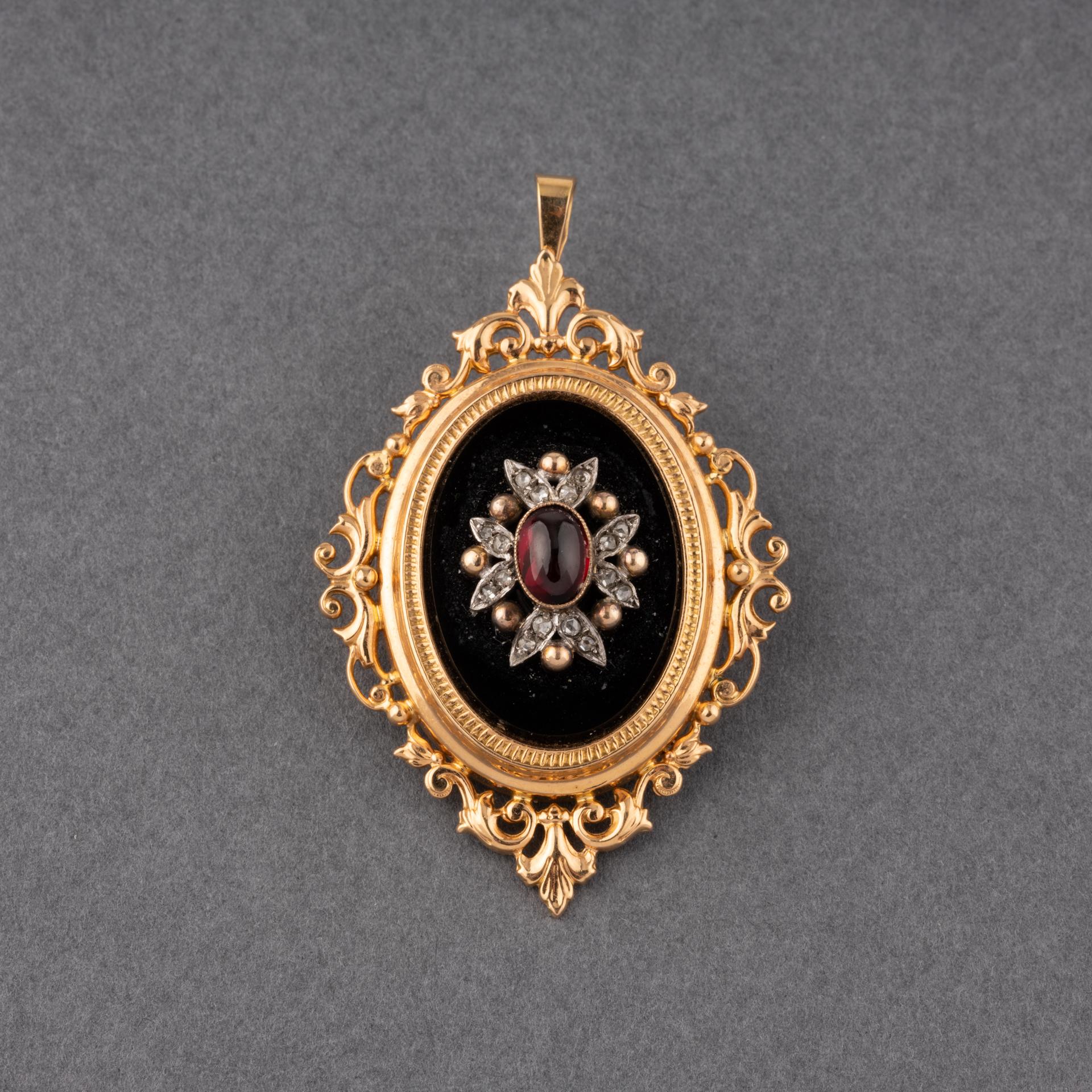 A lovely antique pendant and brooch, made in France circa 1860.
Made in yellow gold 18k, set with Onyx, rose cut diamonds and a Garnet cabochon.
Hallmark for gold: the eagle head. Hallmark of maker.
Dimensions: 55 mm height and 35mm width.
Weight:
