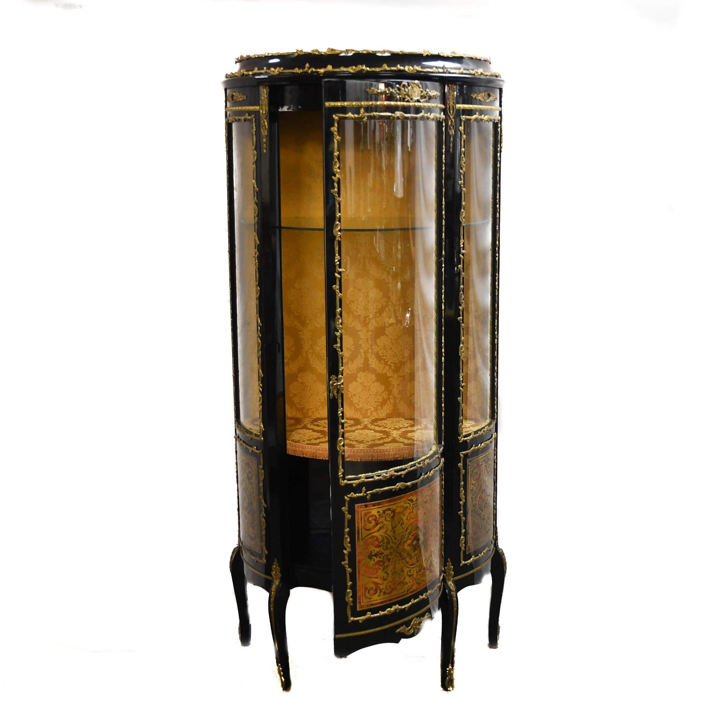 Behold the elegance of the 19th century reimagined. This Antique Napoleon III-Style Bronze-Mounted Curio Cabinet is a showpiece of imperial sophistication and fine craftsmanship. Its oval form, finished in rich black lacquer, is adorned with