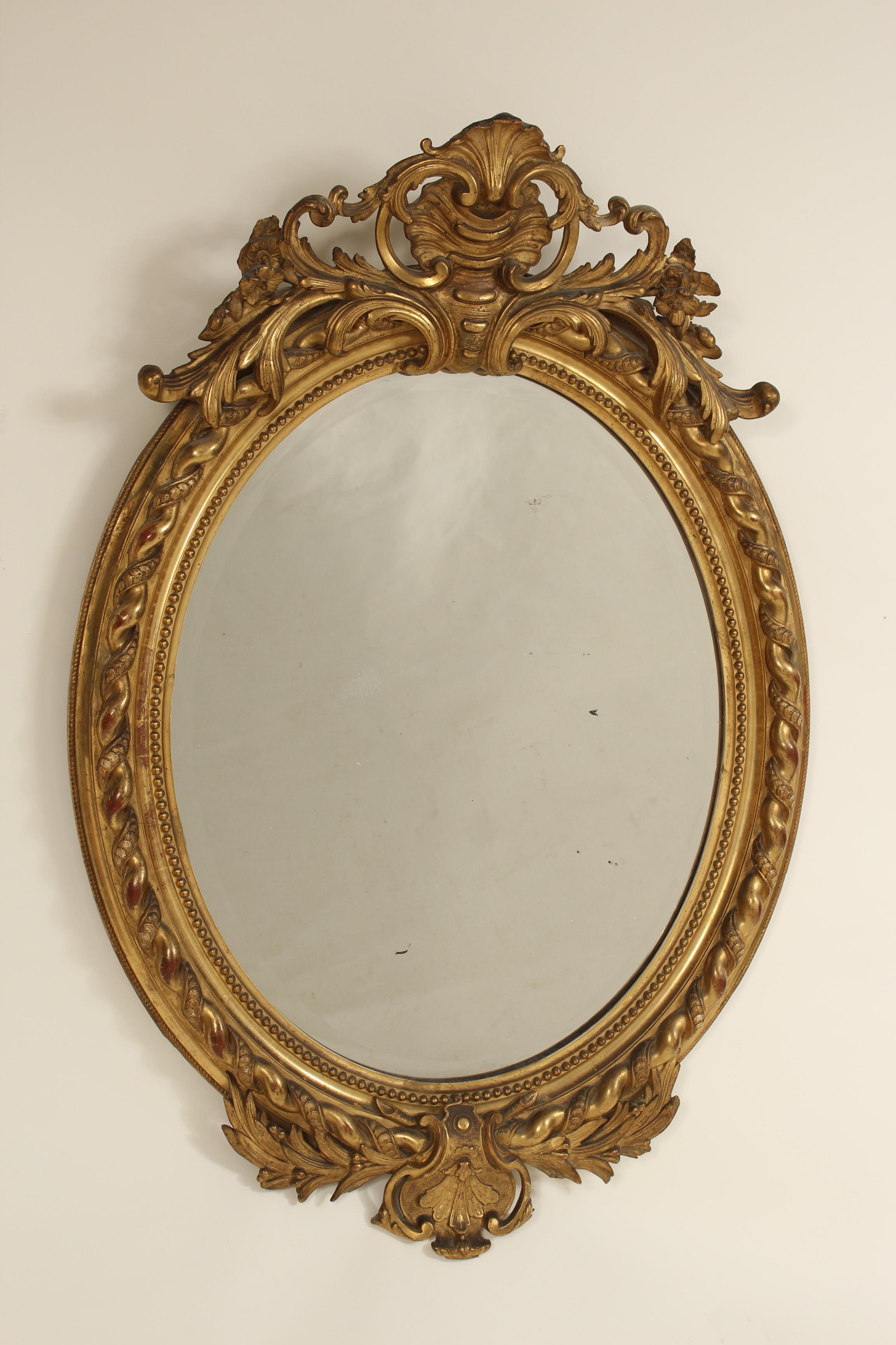 Antique Napoleon III style giltwood and composition mirror, late 19th century. With gold leaf finish and beveled glass.
