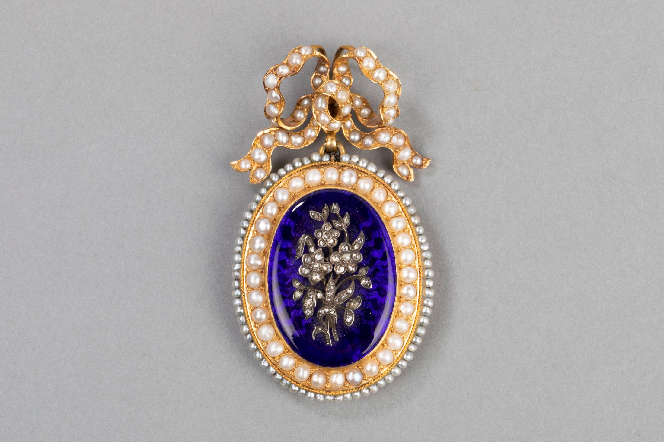Very Beautiful antique Locket. Made in France circa 1850.   
Mounted in Yellow Gold 750 (French hallmark: eagle, mark of the maker) 
 Covered with blue enamel and Natural pearls. 
 Floral theme with rose cut diamonds.  
 Dimensions: 6.5 * 4 cm 