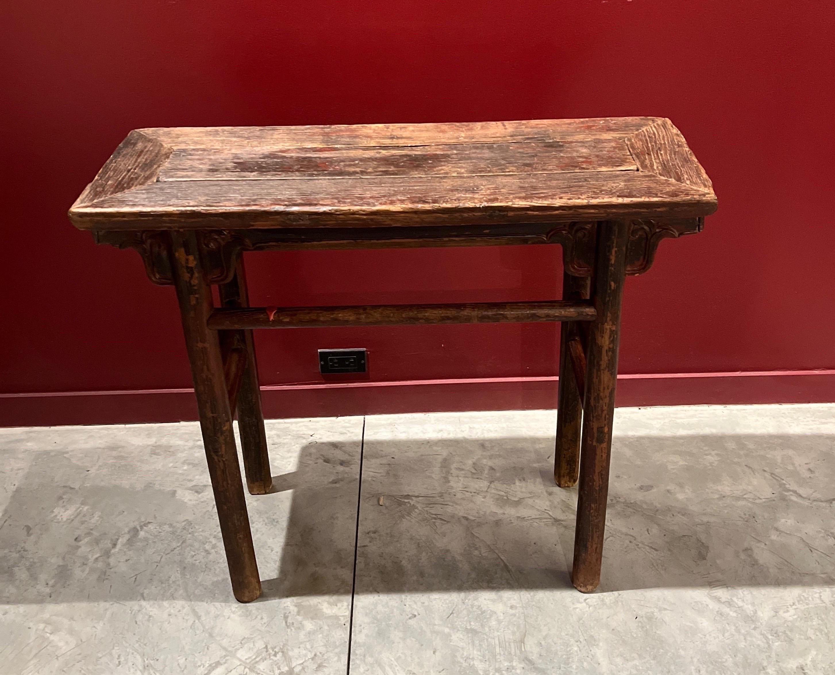 This small and narrow antique altar table, from Shanxi Province, is of simple, classic Ming design.  It's clean lines will complement the most contemporary interior, while providing the warmth and interest of a striking patina reflecting years of