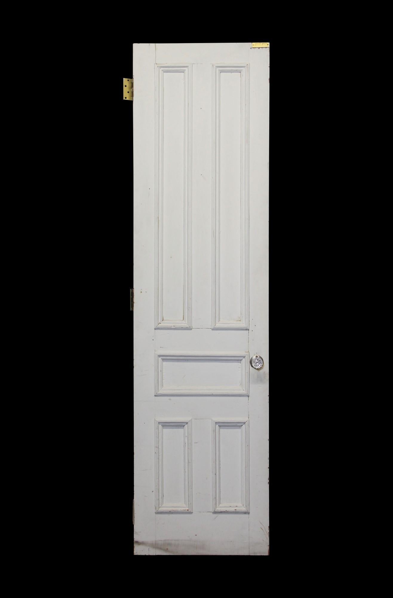 Early 20th century antique white painted wood door done in a five panel deign . Features glass doorknobs and brass hardware. Measures: 94.5 x 25.25. Small quantity available at time of posting. Priced each. Please inquire. Please note, this item is