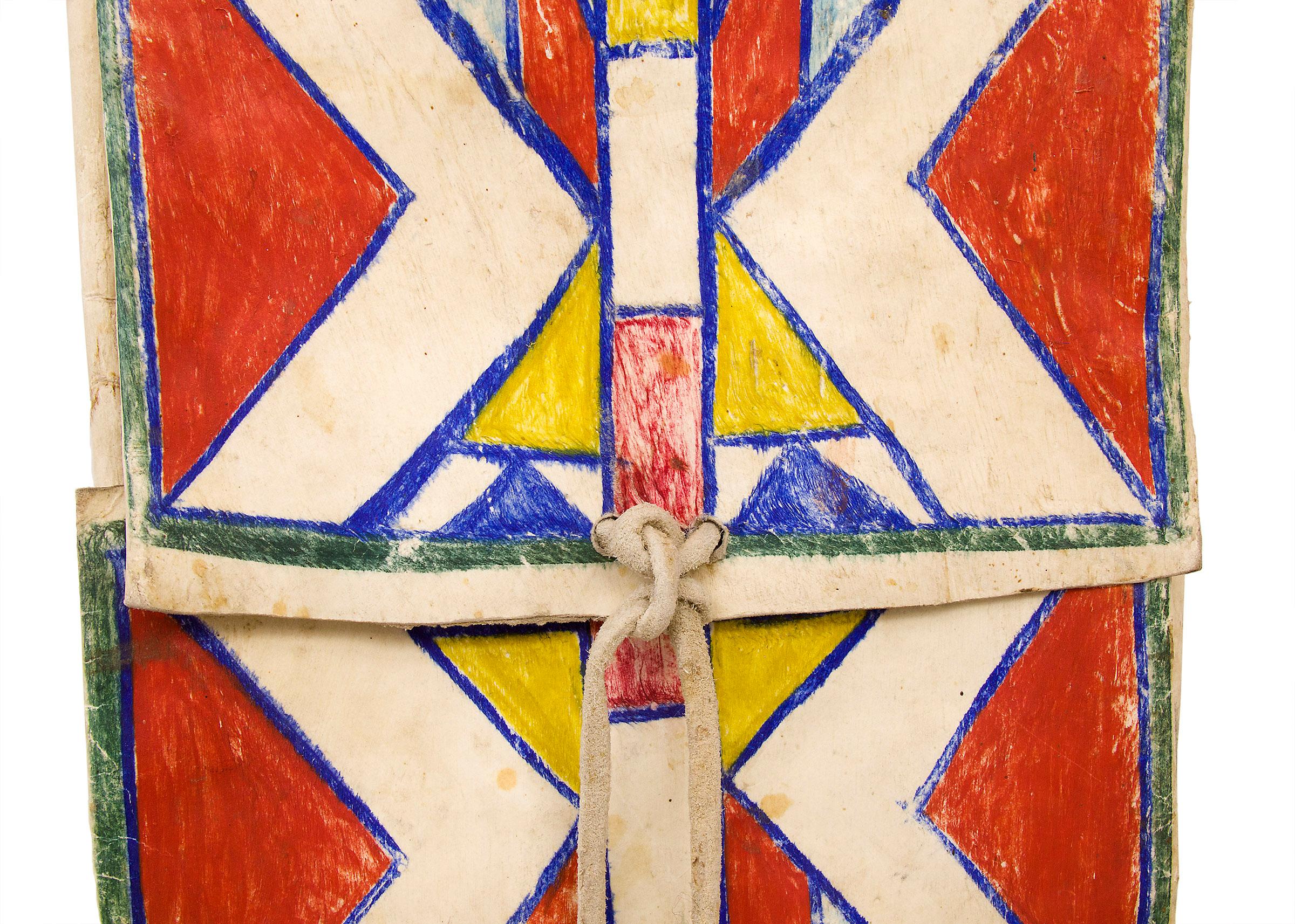 Envelope style parfleche envelope, Crow (Northern Plains), circa 1880. Rawhide with pigments. Painted in abstract/geometric style with double hourglass design in red, blue, green and yellow. Dimensions measure 25 ¼ x 12 x 1 ½ inches.

Very good