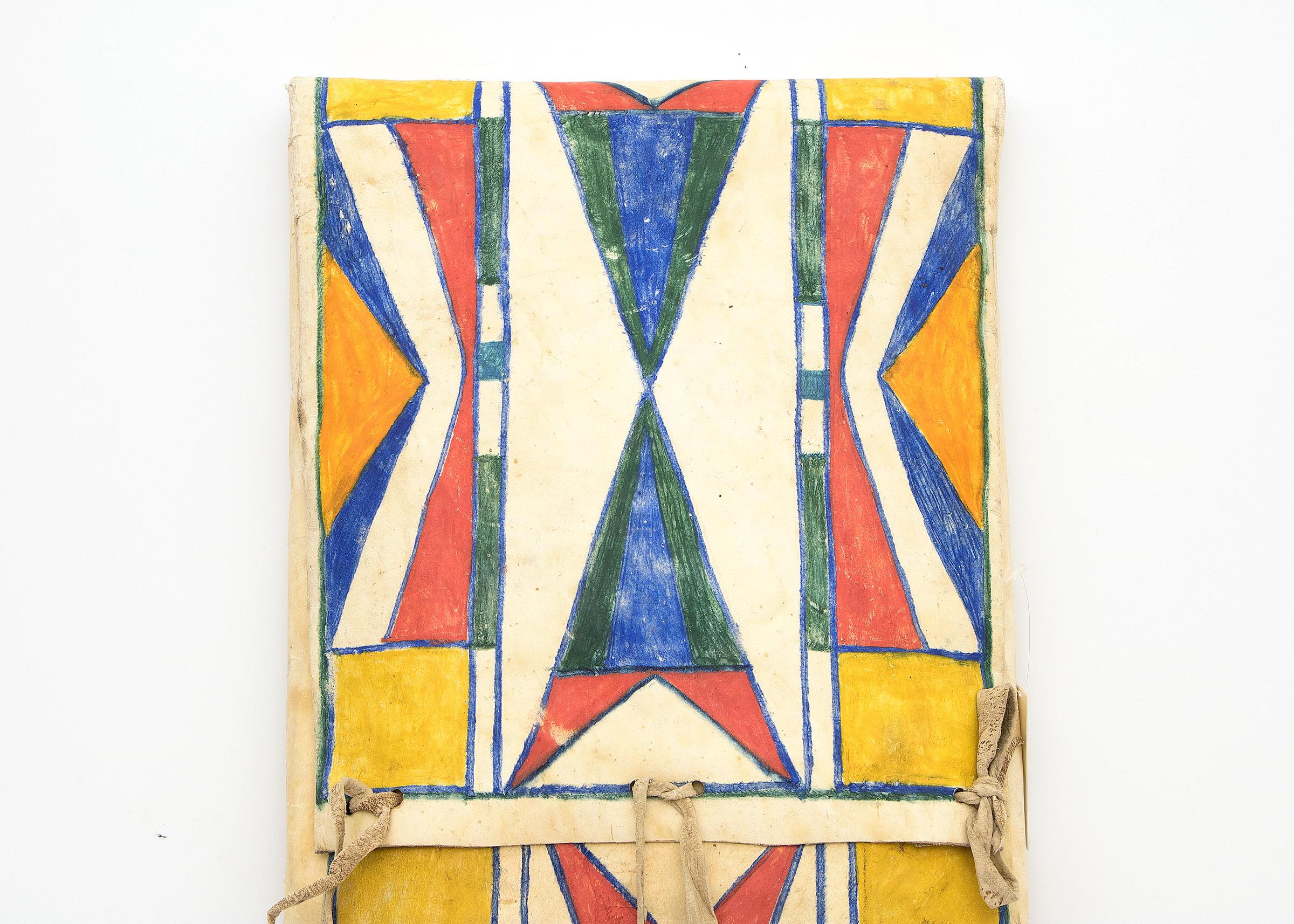 19th century vintage Native American Parfleche container in an envelope form, finely painted circa 1890 in an abstract design with blue, yellow, orange and red by a North American Indian artist of the Plateau Tribe. Makes a stunning wall hanging or