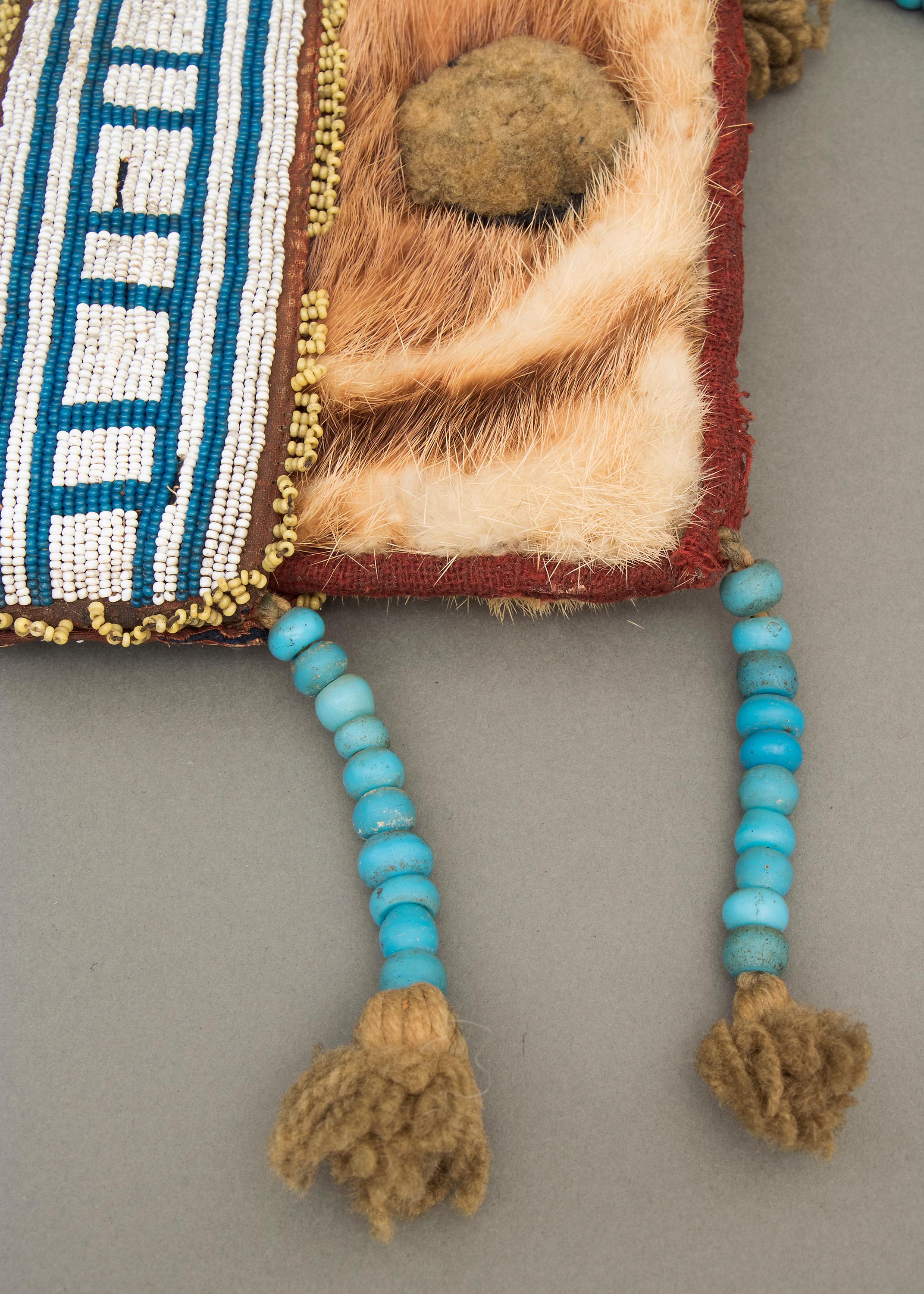 This remarkable antique Northwest Coast Native American hide pouch was created by a member of the Athapaskan tribe (North American Indian) around the middle of the 19th century, known as the Classic Period of American Indian art (predating the