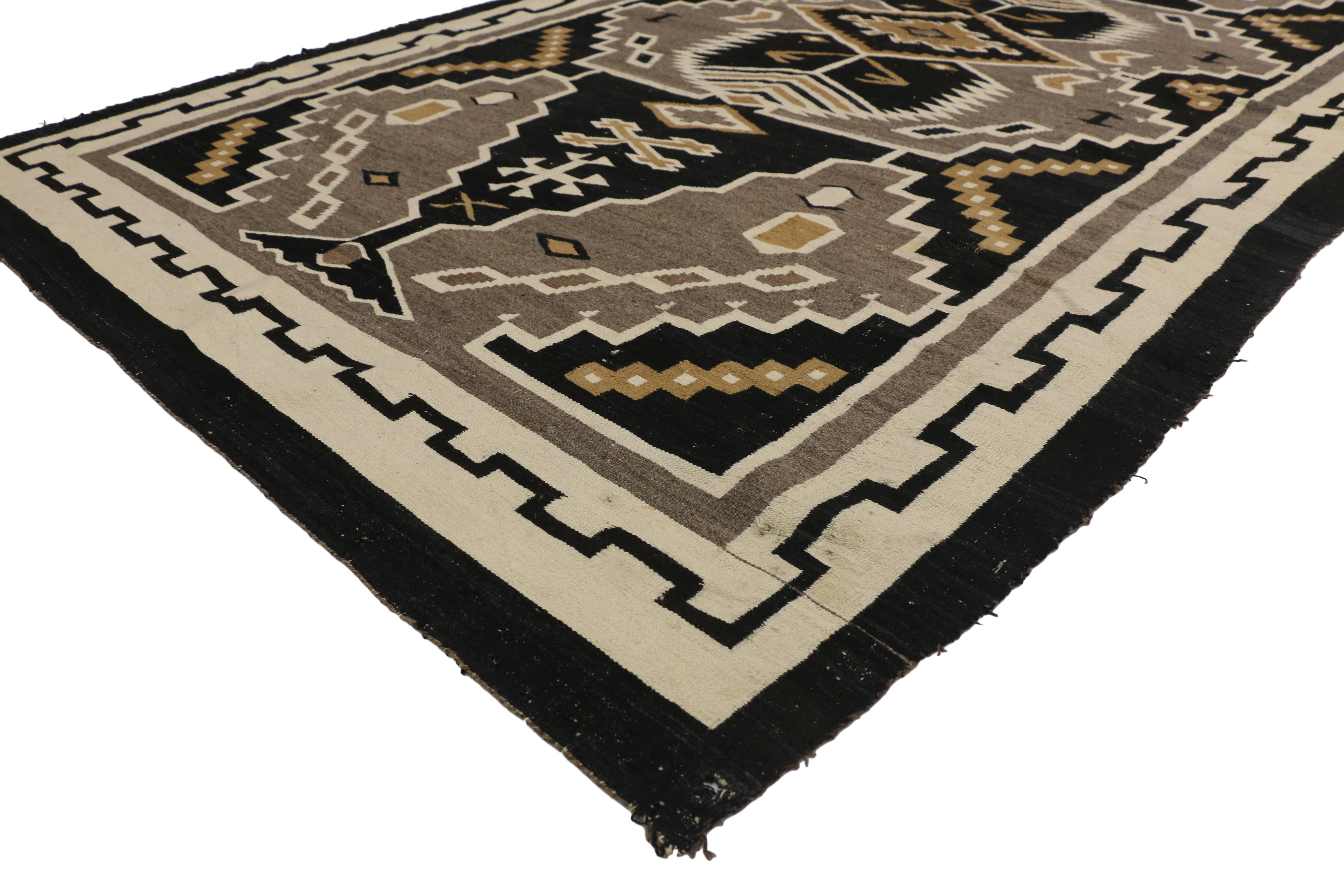 77275, distressed antique native American Indian Kilim rug with Navajo two grey hills style. Captivating and emanating Navajo vibes and Adirondack Lodge style, this handwoven wool antique Native American Indian Kilim area rug features an all-over