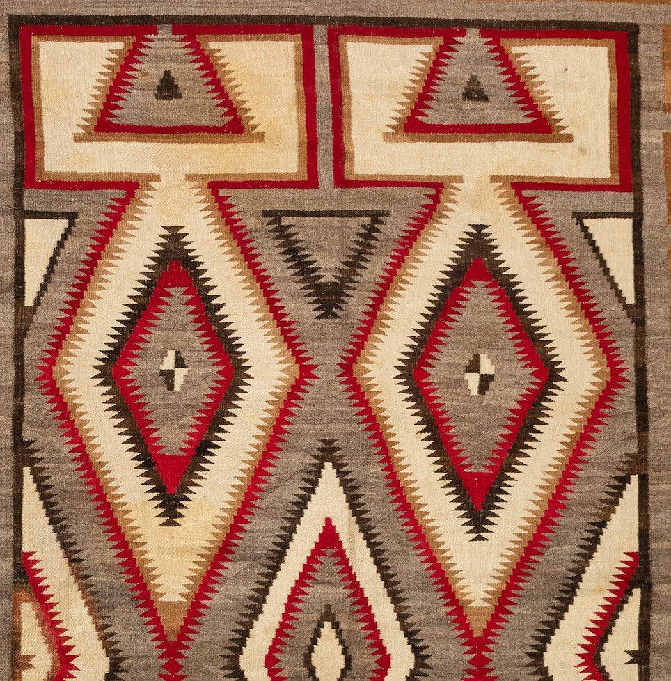 This a large, and therefore rare, antique Native American Navajo Geometric rug, circa 1920s-1930s in grey and ivory and measures 7.7 x 10.8 ft.

From the inception of weaving by the Navajos, circa 1700, weaving has provided an important economic