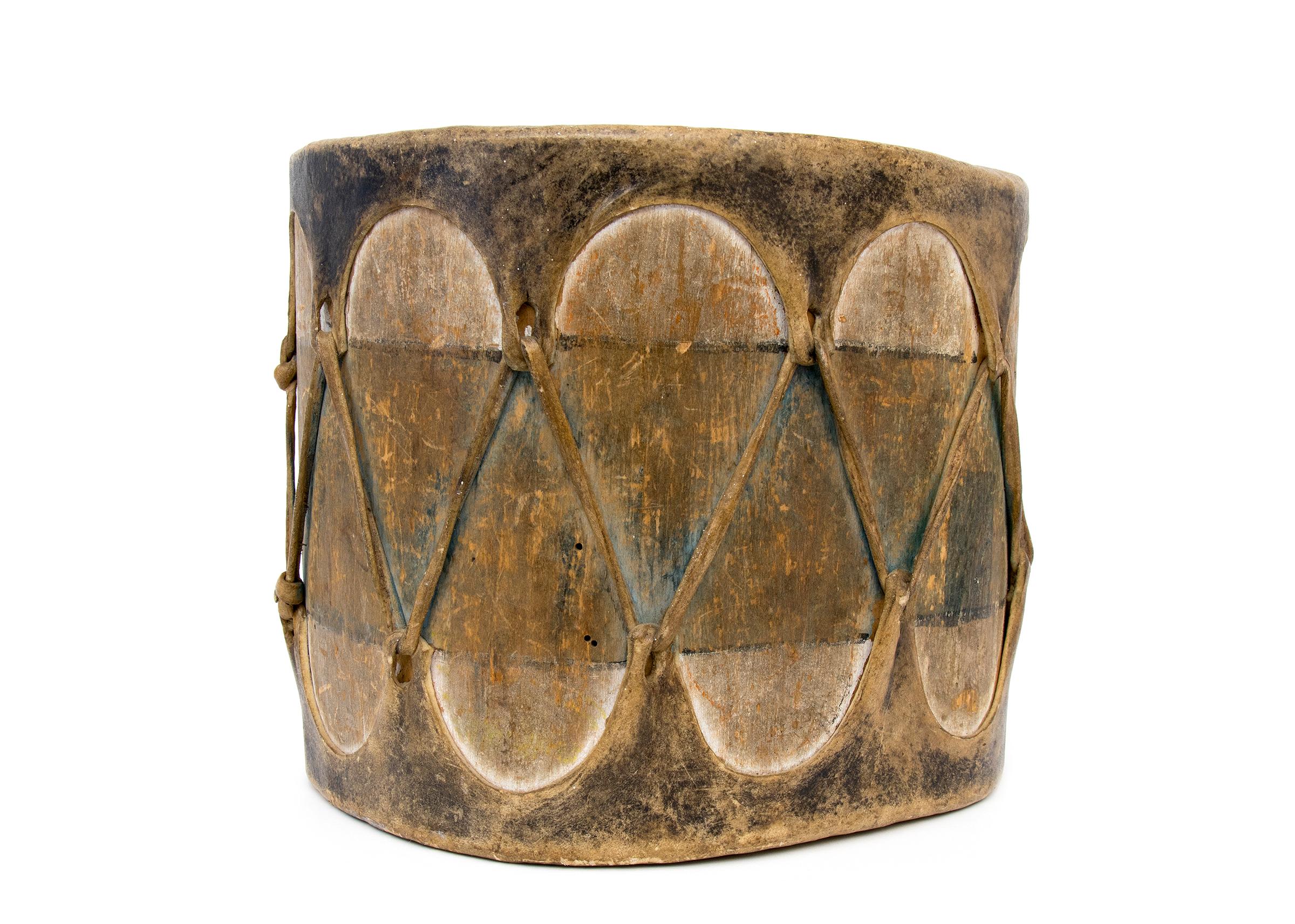 Vintage Southwestern Pueblo drum, Native American instrument, constructed of wood with stretched rawhide and pigments. The drum has a rustic look with great patina, colors include brown, black, white and blue. The Pueblo culture area includes the