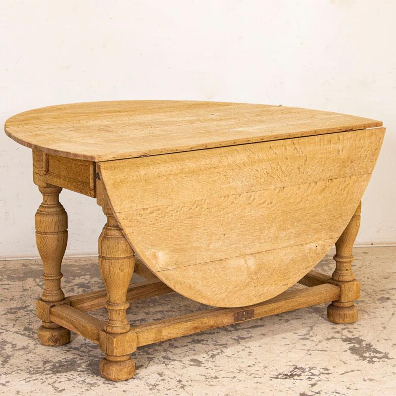 When seen in person, one is drawn to this table thanks to the light, natural oak left raw (but sanded) for a casual European country feel. While closed, this table is just over 4' long, creating a wonderful console table; the two leaves drop for a