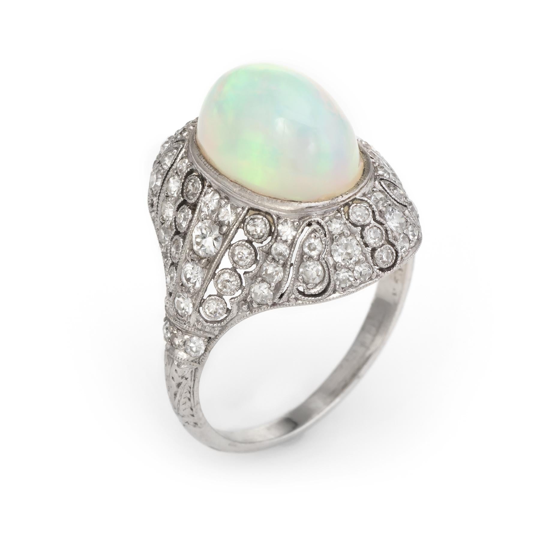 Elegant & finely detailed Art Deco era ring (circa 1920s to 1930s), crafted in 900 platinum. 

Centrally mounted natural opal measures 12mm x 8mm (estimated at 4 carats), accented with 78 graduated single & old mine cut diamonds totaling an