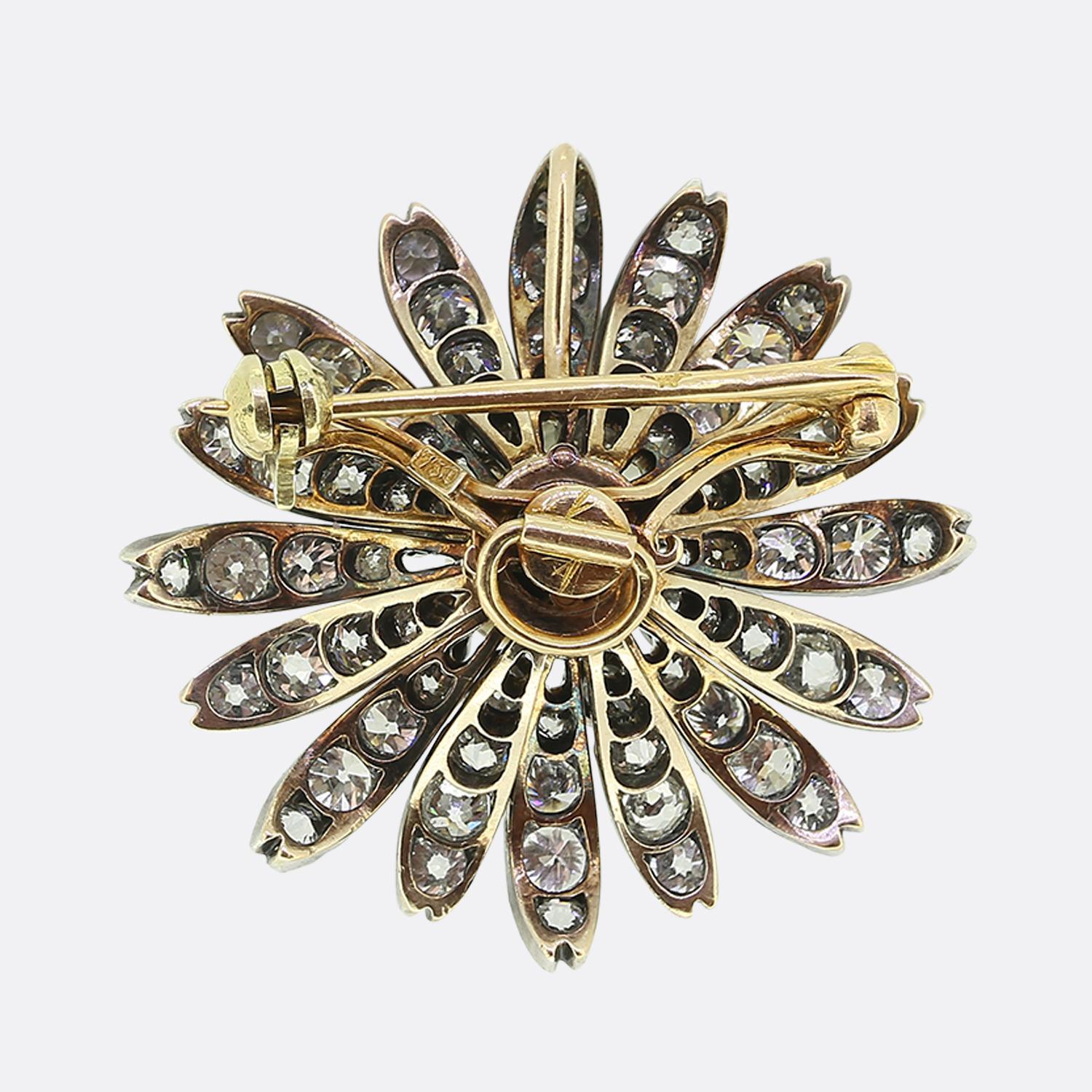 Here we have a wonderful diamond flower brooch dating back to the late Victorian era. The brooch is crafted in 18ct yellow gold and silver and features a single natural pearl at the centre with a beautiful lustre. The pearl is surrounded by old cut