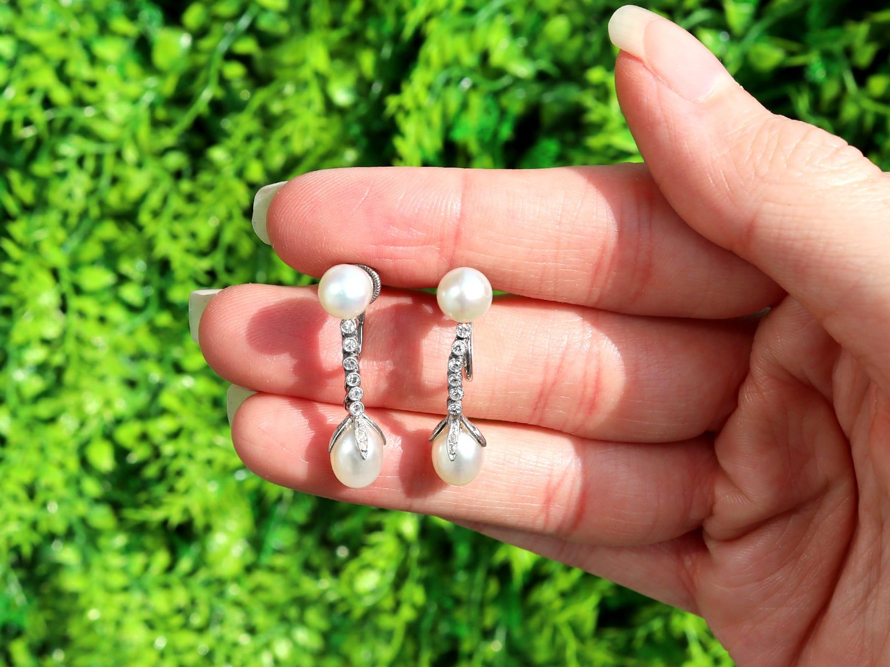 A stunning pair of antique natural white pearl and 0.36 carat diamond, platinum drop earrings; part of our diverse antique jewelry and estate jewelry collections.

These stunning, fine and impressive antique pearl and diamond drop earrings have been