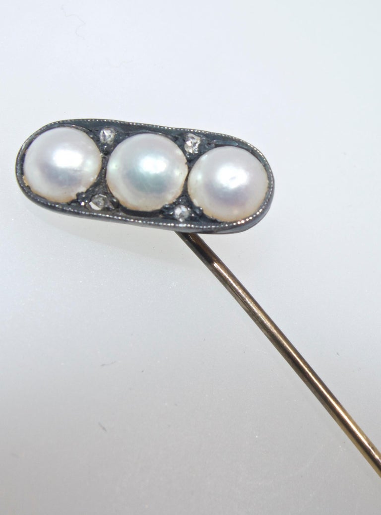 Natural pearls accented by rose diamonds set in silver and topped with gold, this is an early antique stick pin circa 1860.  During the 19th century and early 20th century men routinely wore stickpins in their ties.  Today both men ad woman sport
