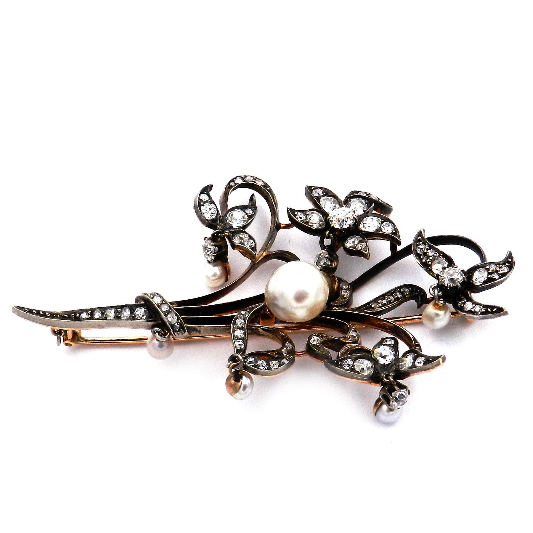 Antique Natural Pearl Diamond Flower Brooch in 18K Gold circa 1890

Enchanting antique pearl and diamond brooch in the shape of a large blossoming branch, crafted from 18K/750 rose gold and silver. The sweeping blossoms and leaf tendrils are set