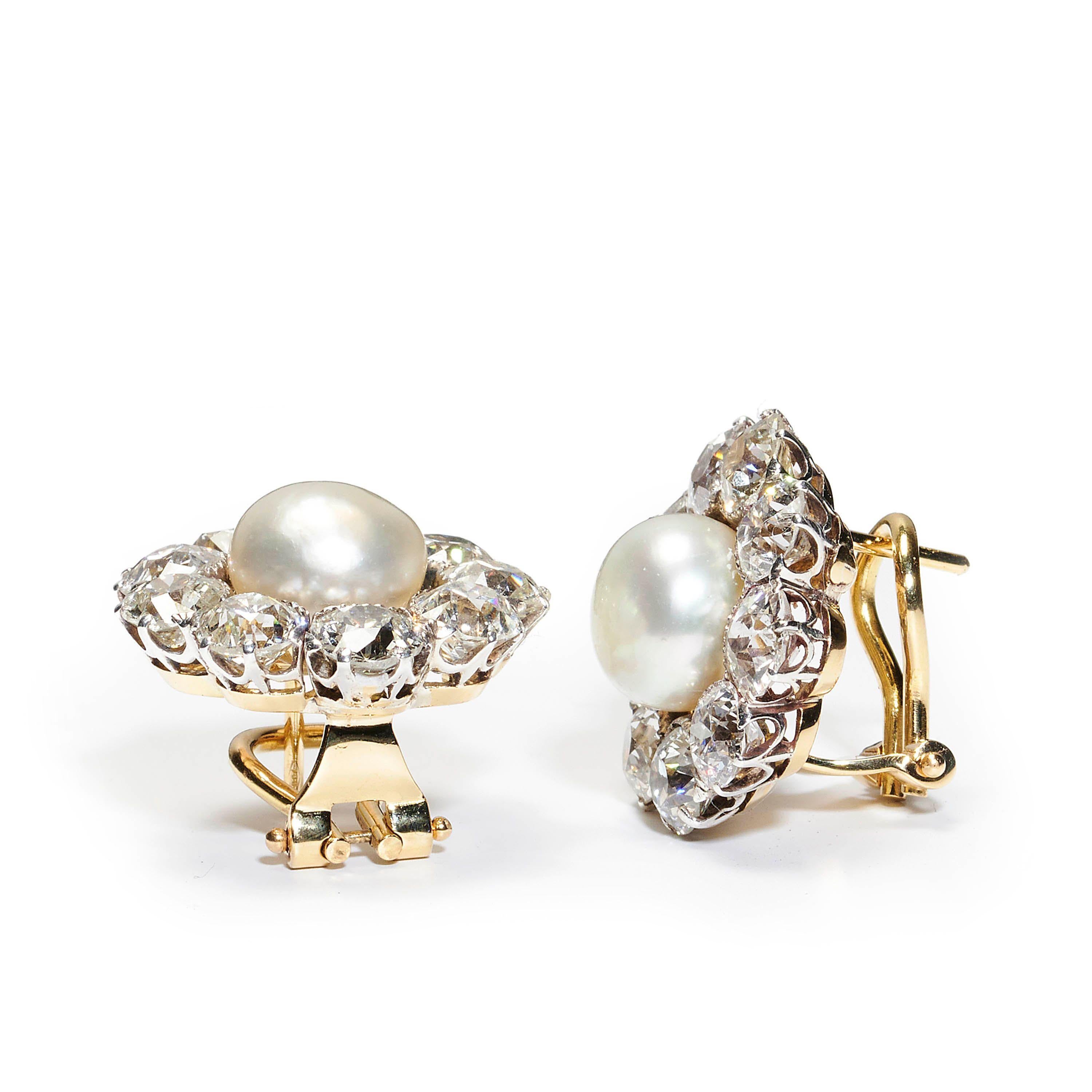 An antique pair of natural pearl and diamond cluster earrings, with bouton shaped natural pearls in the centre of a cluster of nine, European old-cut diamonds, with an estimated total weight of 10.00ct, in platinum crown claw settings, on gold