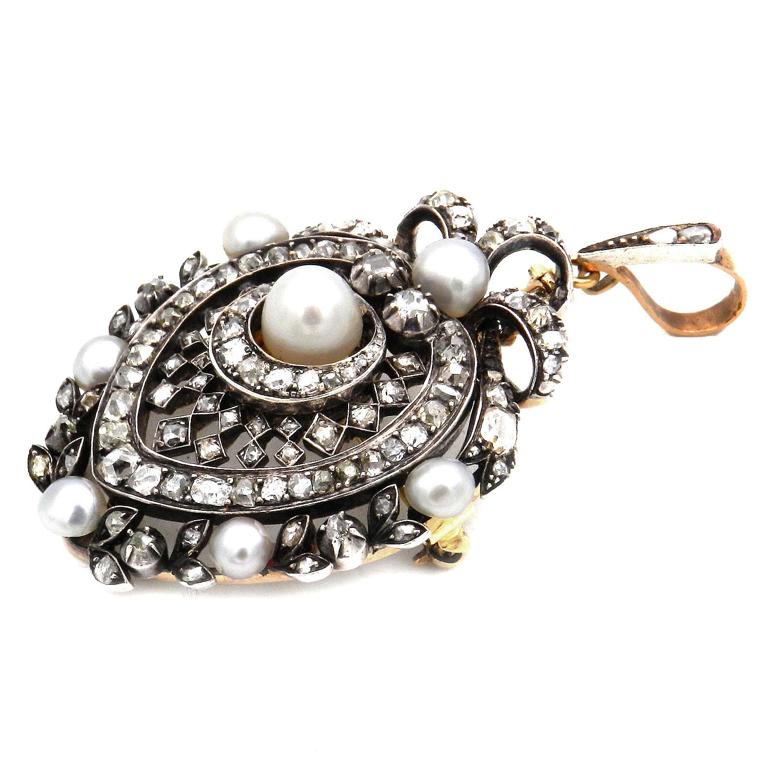 Antique Natural Pearl Diamond Gold and Silver Pendant Brooch circa 1890

Magnificent, antique heart-shaped diamond pendant, pierced and set with two large natural pearls, set throughout with 115 old-cut diamonds and rose-cut diamonds totaling 4.5