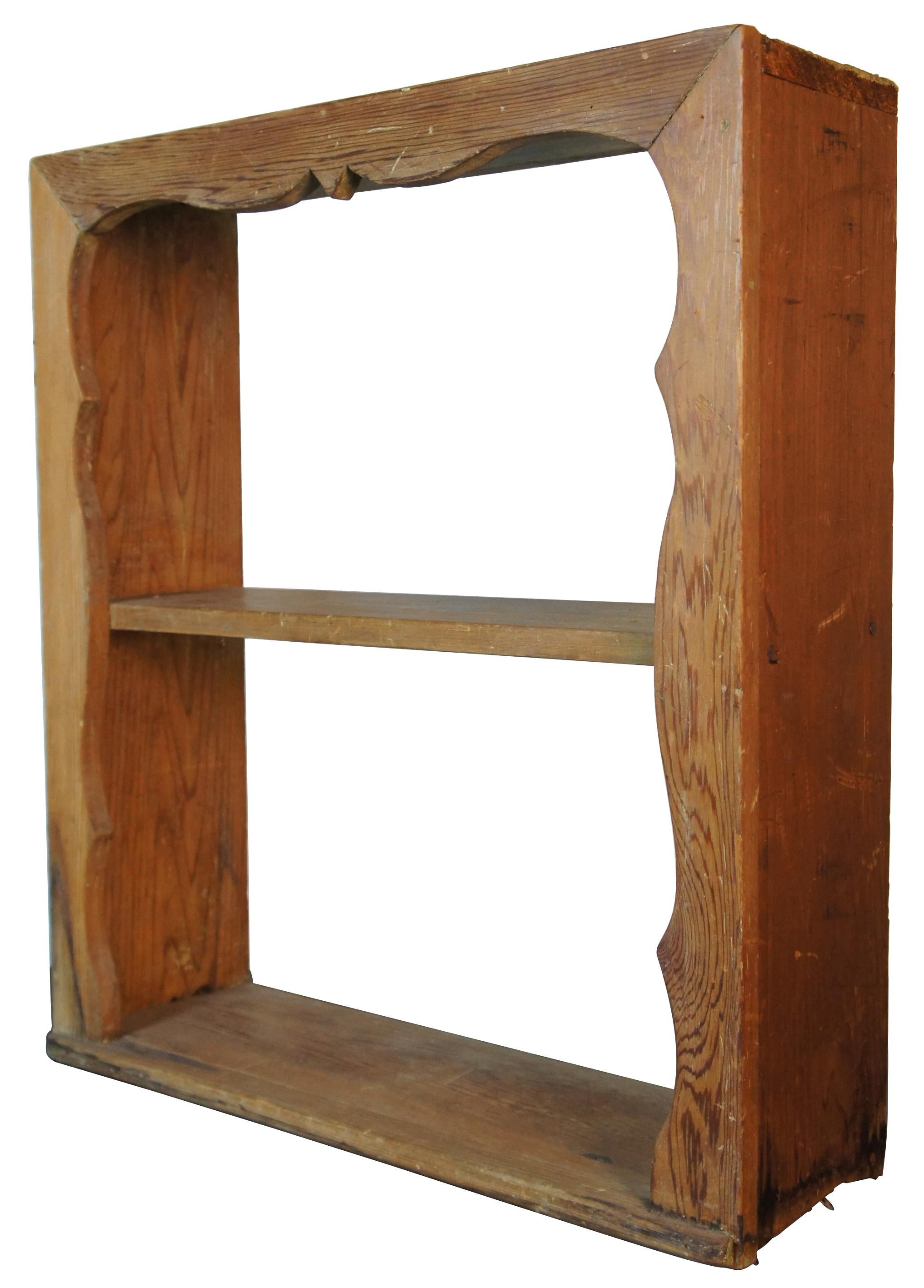 Antique natural pine wooden wall shelf with two tiers and serpentine form with proscenium style framed around the front. Measure: 27