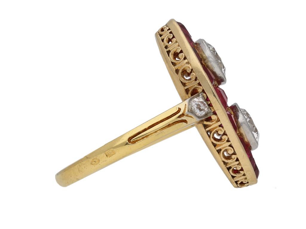 Antique marquise ruby and diamond ring. Vertically set to the centre with two round old cut diamonds in slightly raised open back rubover millegrain platinum settings, with a combined weight of 2.30 carats, encased within a marquise form set with