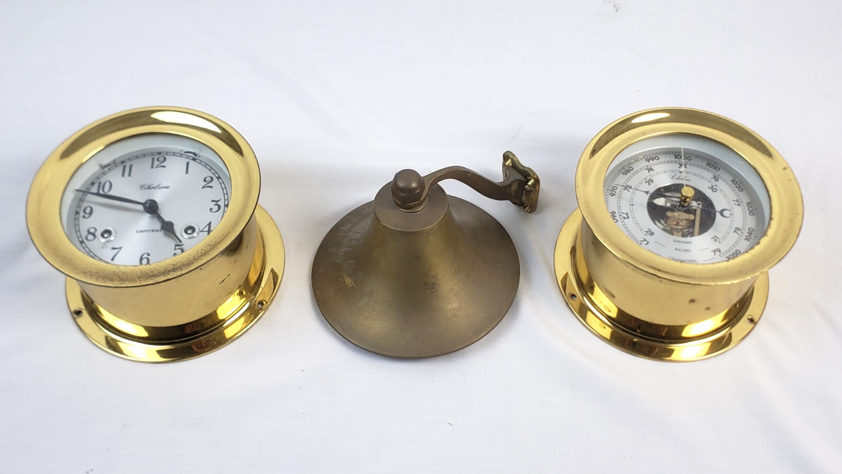This antique nautical brass ship's clock and barometer were made by the Chelsea Clock Company of the United States and date to approximately 1920 and done in the period style. The bell in this grouping shows no maker's mark. The clock and barometer