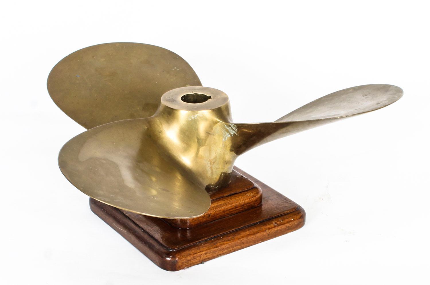 A large early 20th century brass three blade propeller dated 1913 and stamped 'Gaines', now mounted on an oak plinth, each blade length approx 25cm,.

This exciting nautical collectable is also stamped 19 x 13 LH.

Add this wonderful maritime