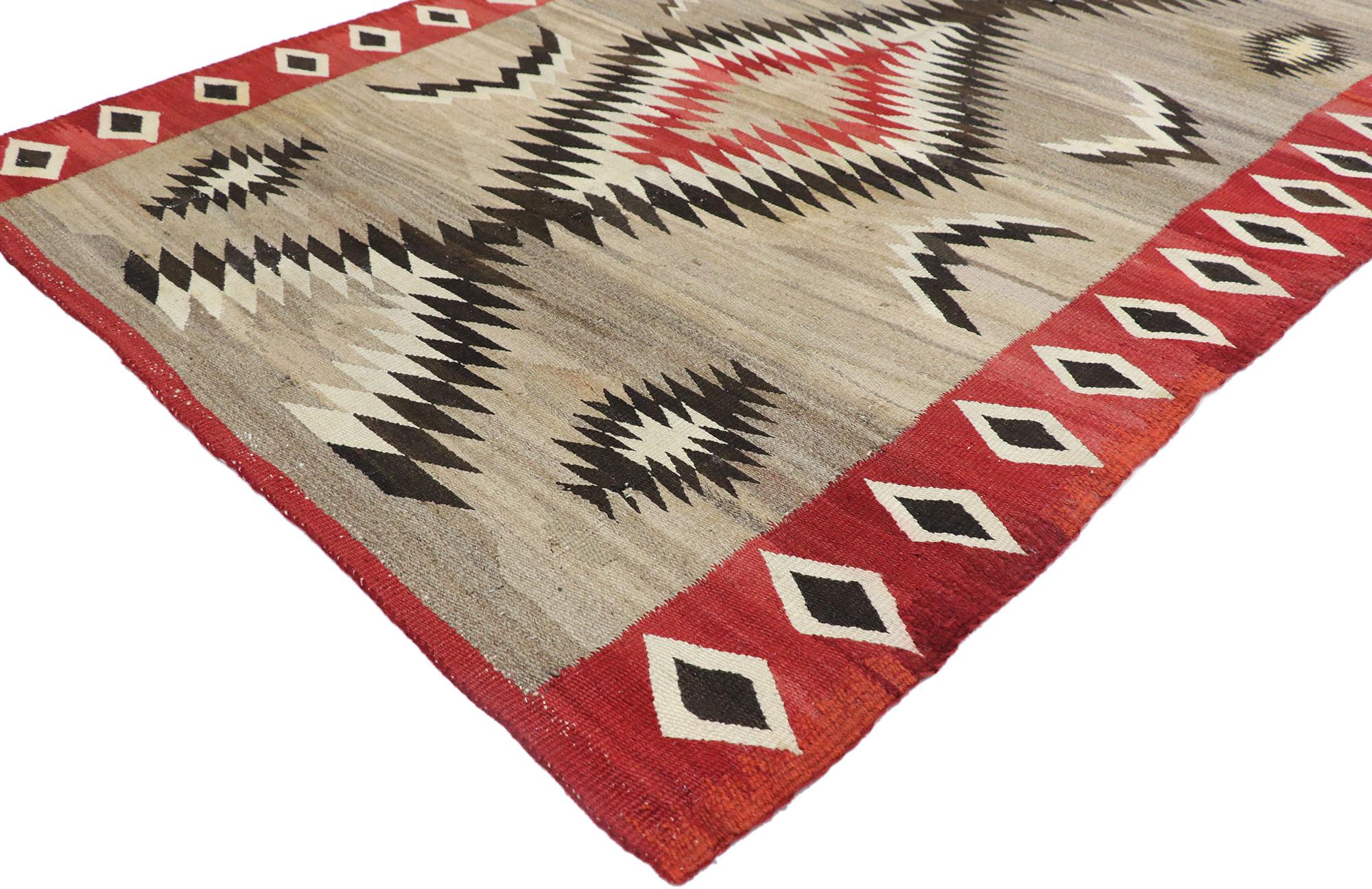 77803 Antique Navajo Eye Dazzler Rug, 04'06 x 06'04. Eye Dazzler Navajo rugs, crafted by the indigenous Navajo people of the Southwestern United States, are renowned for their intricate weaving, vibrant hues, and captivating geometric patterns.