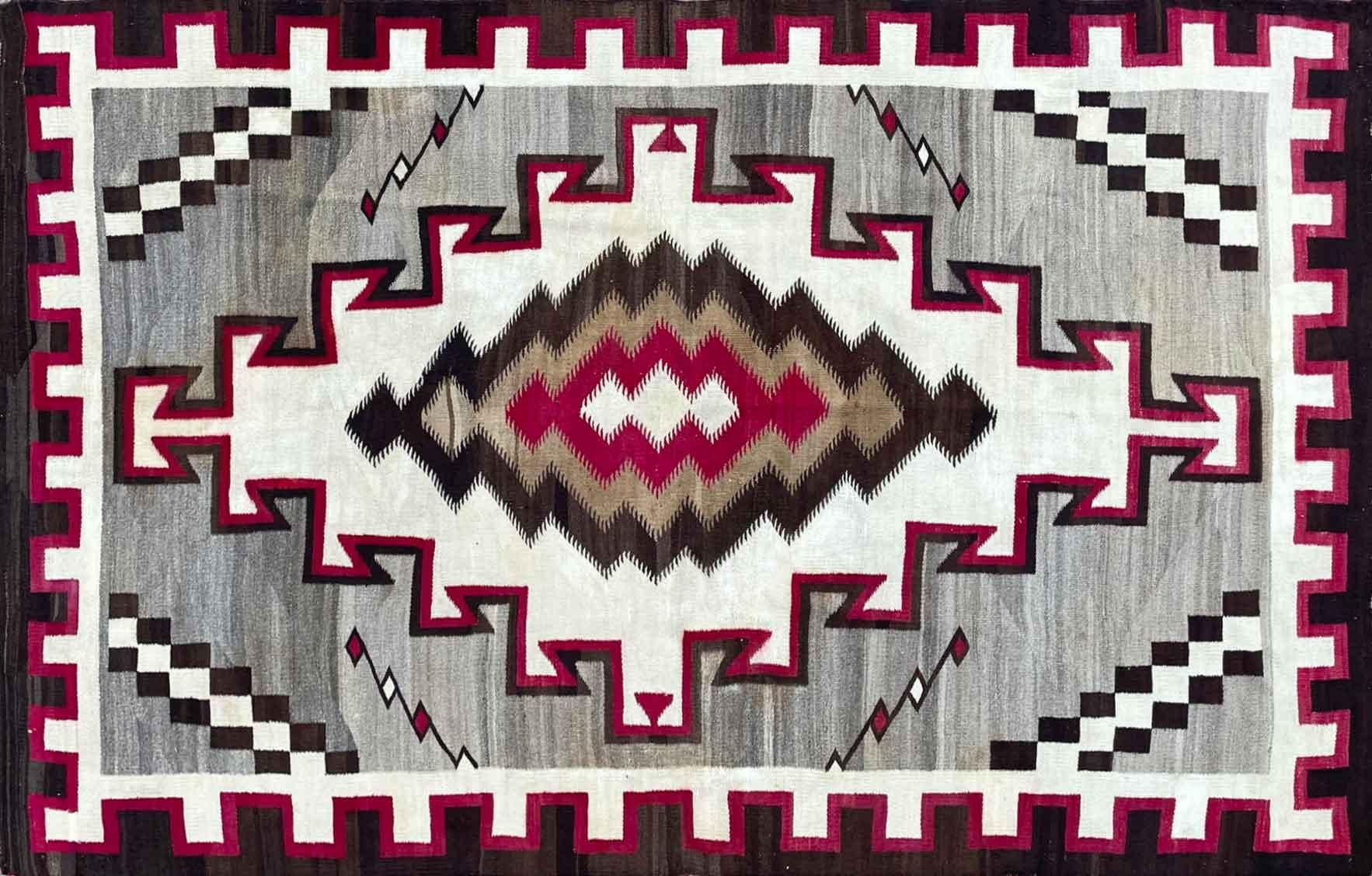 On offer is a rare antique Navajo rug, a truly magnificent piece of textile, circa 1920s-1930s. Distinguished in its massive size (68 by 110 inches), intricate designs and superb workmanship, this Klagetoh weaving is rather unusual in that instead