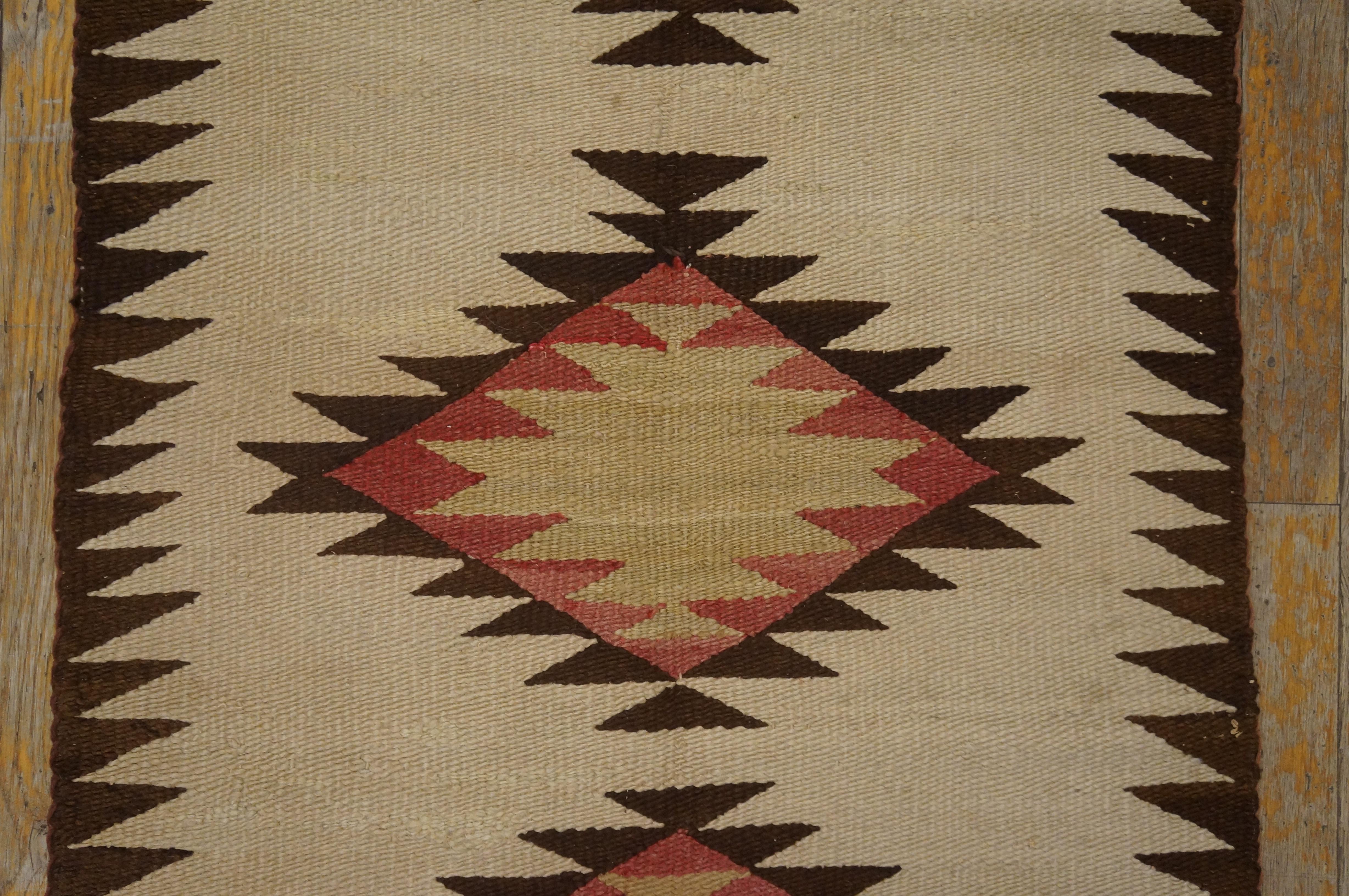 Antique Navajo rug with ivory color and 2'2