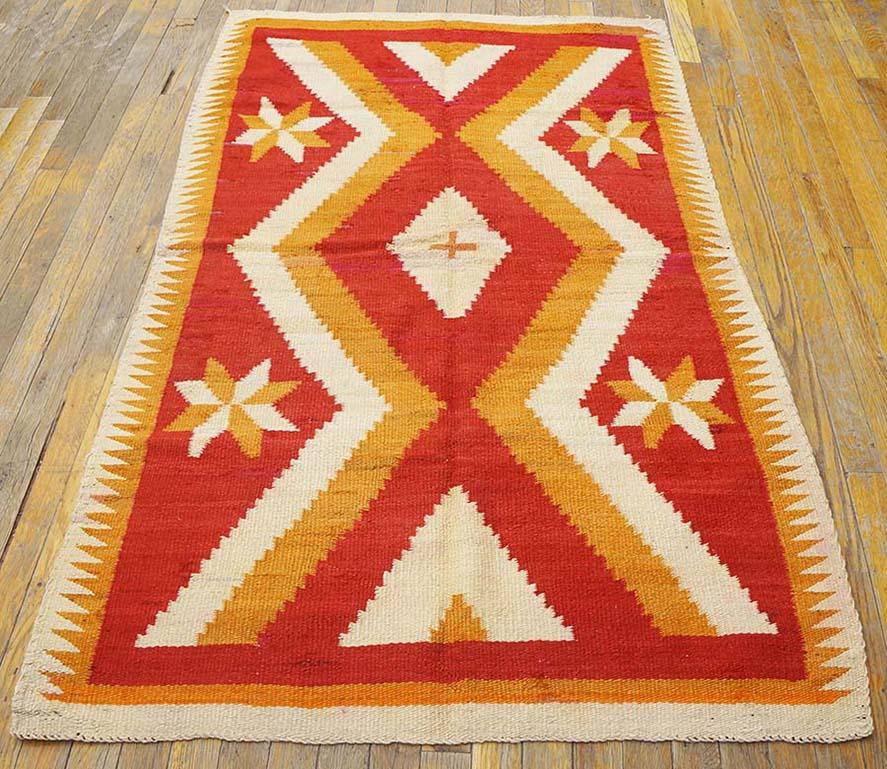 This truly antique piece shows the red and orange-rust synthetic dyes characteristic of the later 19th century. A bold and floating doubly pinched pattern results in a central nested lozenge and end en suite triangles. Four stars in the lateral