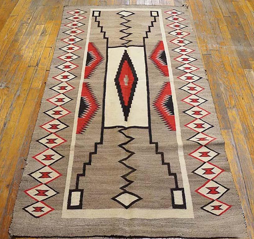 The “Storm Pattern” with four stepped lightning flashes emanating from a central rectangular cloud, is one of the most [popular of the post 1900 Navajo patterns. Here both field and lozenge chain lateral borders are light, natural grey while the