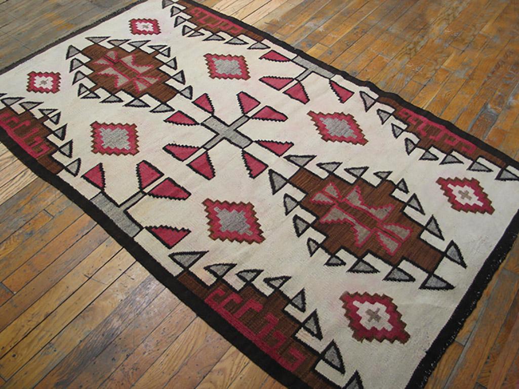 Not much grey here, but a pattern related to the iconic “Two Grey Hills” style, with two full and four half stepped and triangle pendanted medallions on an ecru ground. Central row of grey crosses and numerous supporting brown and grey stepped