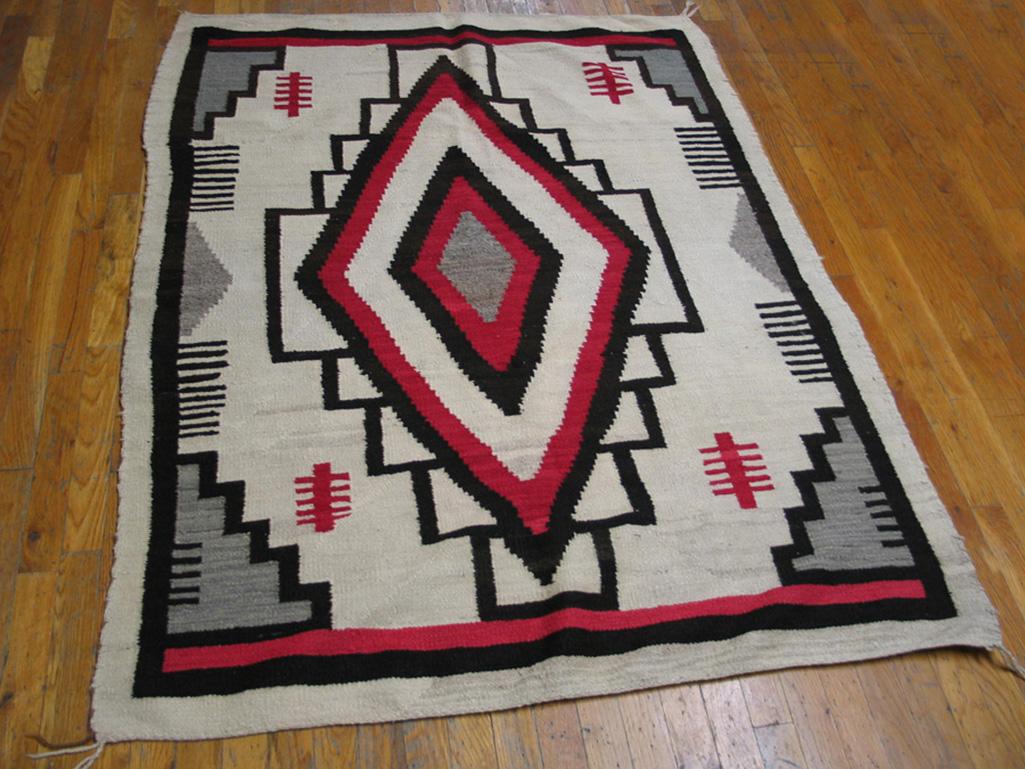 This vintage Southwestern scatter reduces a Caucasian-derived lozenge and stepped surround to its essentials with a bold execution in ecru, red and black. Stepped triangle grey corners and comb trees and edgings. Excellent condition. 