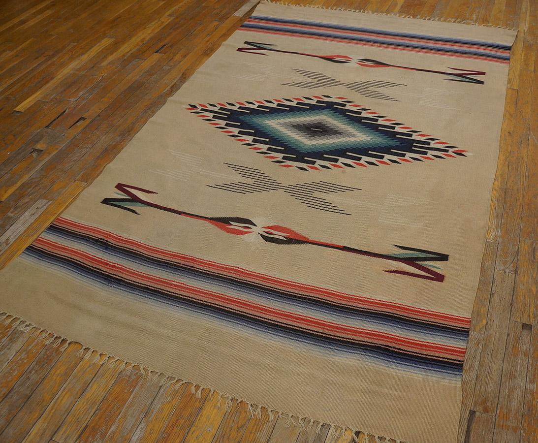 Antique Navajo rug with ivory color and 4' 4'' x 6' 9'' size.