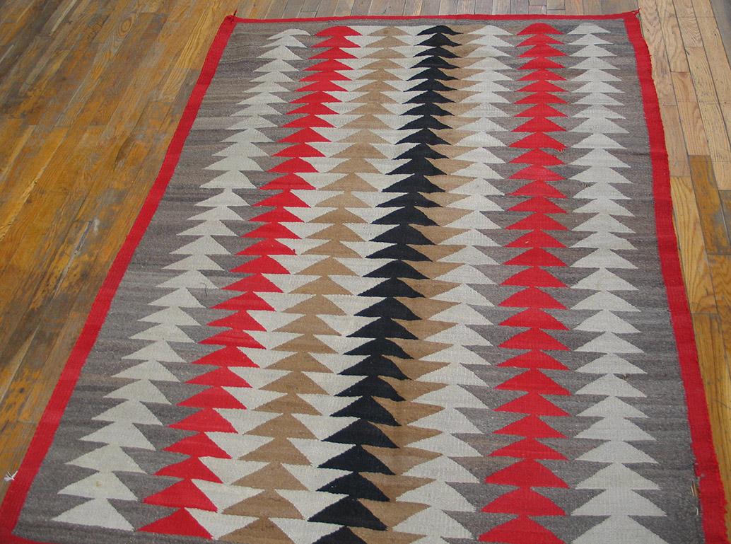The side borders are a wonderfully abrashed natural grey wool and one tilts in, pushing the triangle-herringbone field columns over. There is a central black column which organizes the symmetric lines in grey, red and cream. We have several of these