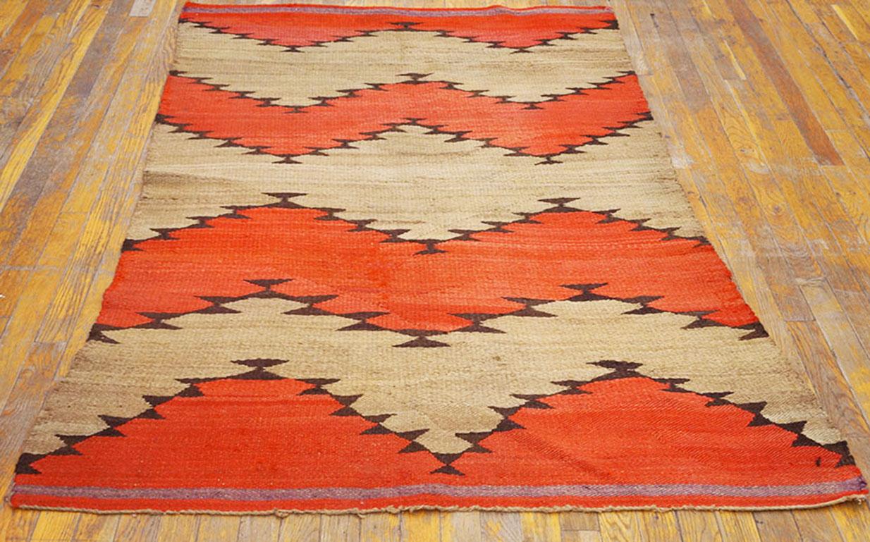 Make it big and keep it simple. Bold, barbed edged red bands zig and zag across the abrashed undyed wool ground with no borders to hem in the movement. The irregularity in width of the bands gives the rug a true handmade character. Excellent