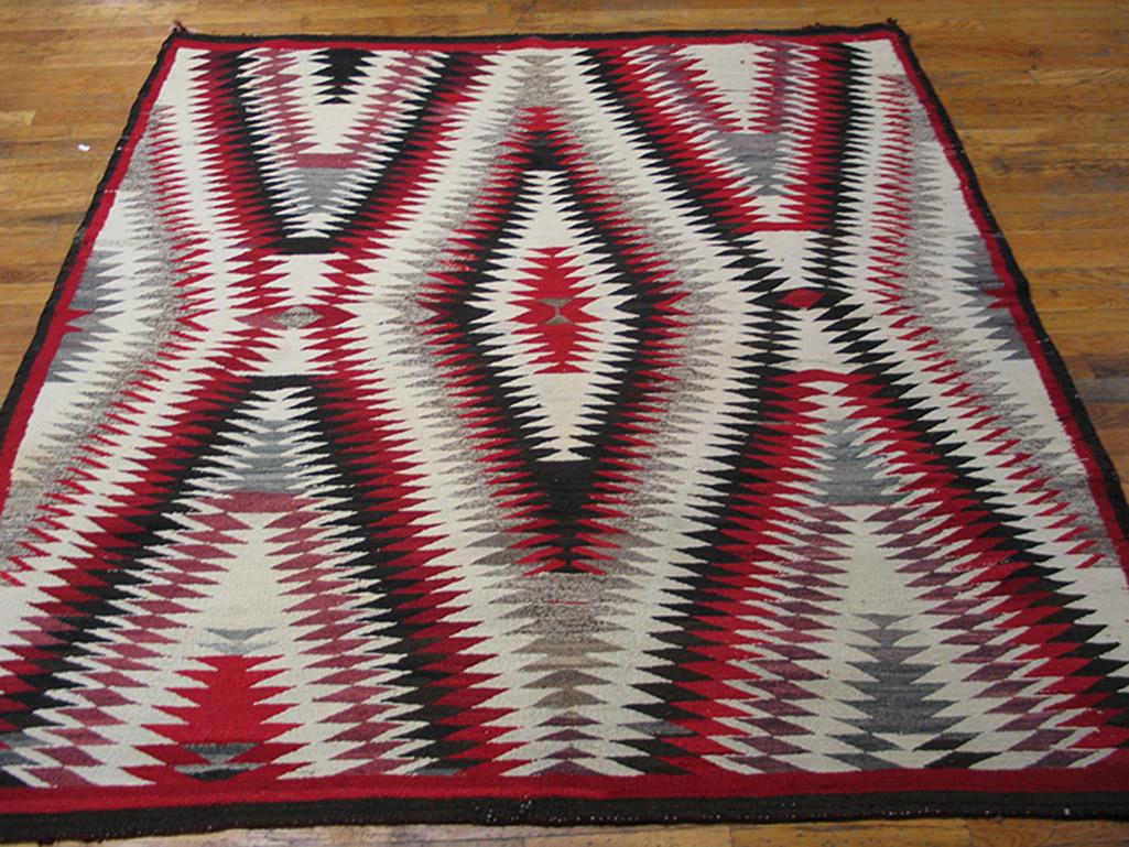 Unusually square, this is a vibrating double X and lozenge pattern, all nested and jagged lines, detailed in red, ecru, black and grey. The narrow red border is an afterthought and scarcely limits the explosive pattern that extends beyond the frame.