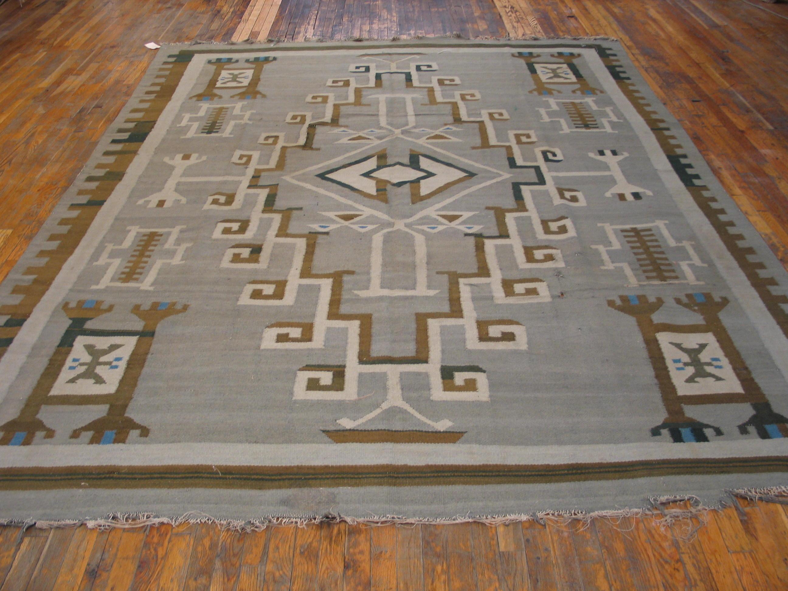 This is a very rare giant vintage/antique Navajo carpet in a Two Grey Hills Caucasian – inspired stepped and hooked open medallion outlined in cream and rust-red on a light grey natural ground, with ivory and red corner squares and other geometric