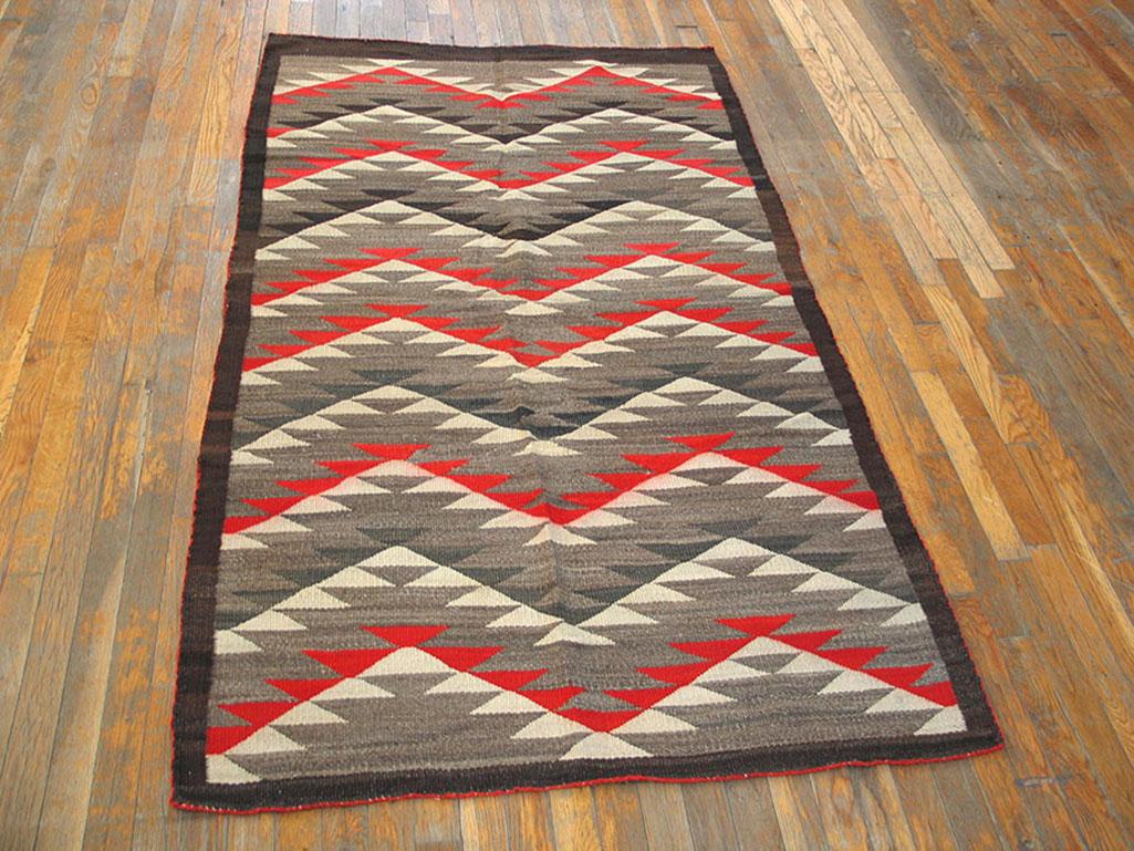All triangles and bold zig-zags in orange-red, charcoal, dark grey and ivory created an upward and downward mobile pattern within a narrow abrashed charcoal border. Vintage rug in good condition with bold, totally consistent drawing.