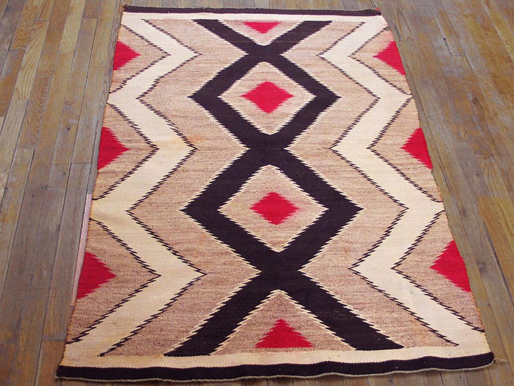 Navajo weavers just love zig-zags, be they small or, as here, bold, defining a central column of soft grey and red diamonds. The black central column is the most striking motif and the nearby tones grade off through grey to sand with no side