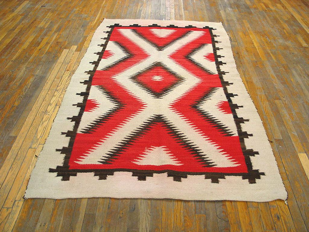 A thin black border with a “paddle” pattern closely frames a classic red, black and cream zig-zag and central lozenge pattern in which all elements have serrated edges. Gives an effect of a rug within a rug. Versatile size for this antique in fine