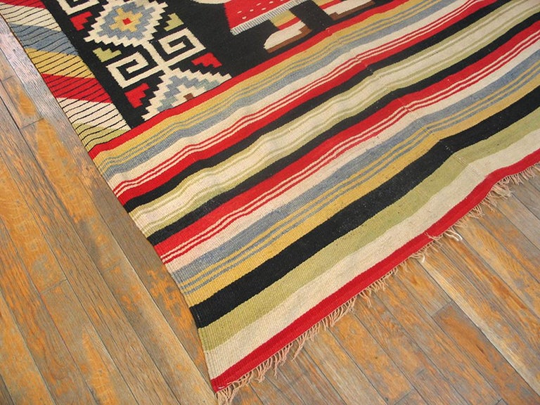 Not Navajo, but Mexican, as indicated by the two-piece construction and the stylized Aztec peasant composite figure. Very wide palette including: off white, beige, black, straw, orange-red and teal. Very wide striped panels flank the central image.