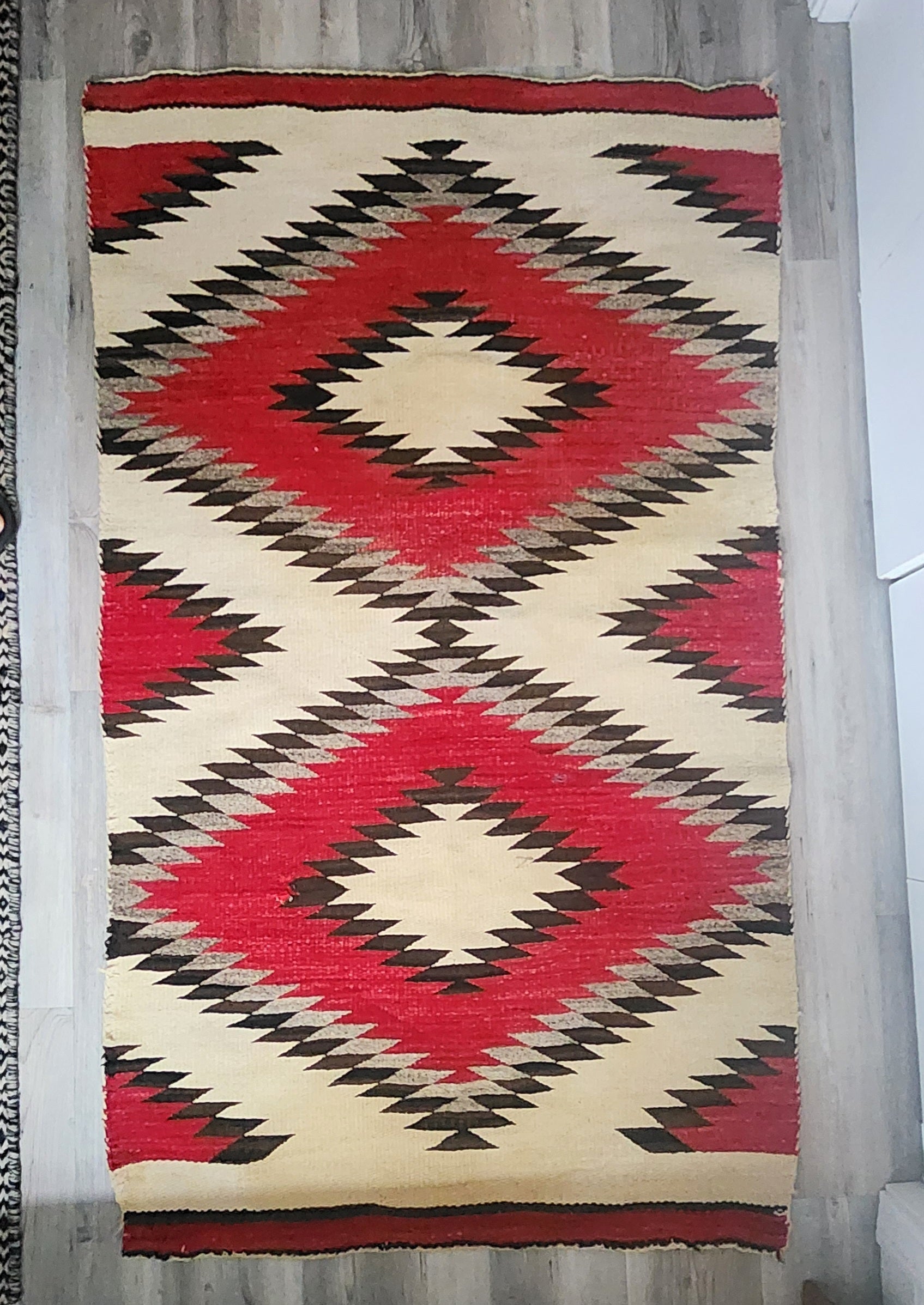 Circa 1900, Navajo weaving, likely Ganado, with a very simple and modern design. Nice mottling of the natural colors. This is a very bold weaving, likely a double saddle blanket. This weaving is in good, as found condition. Please examine all
