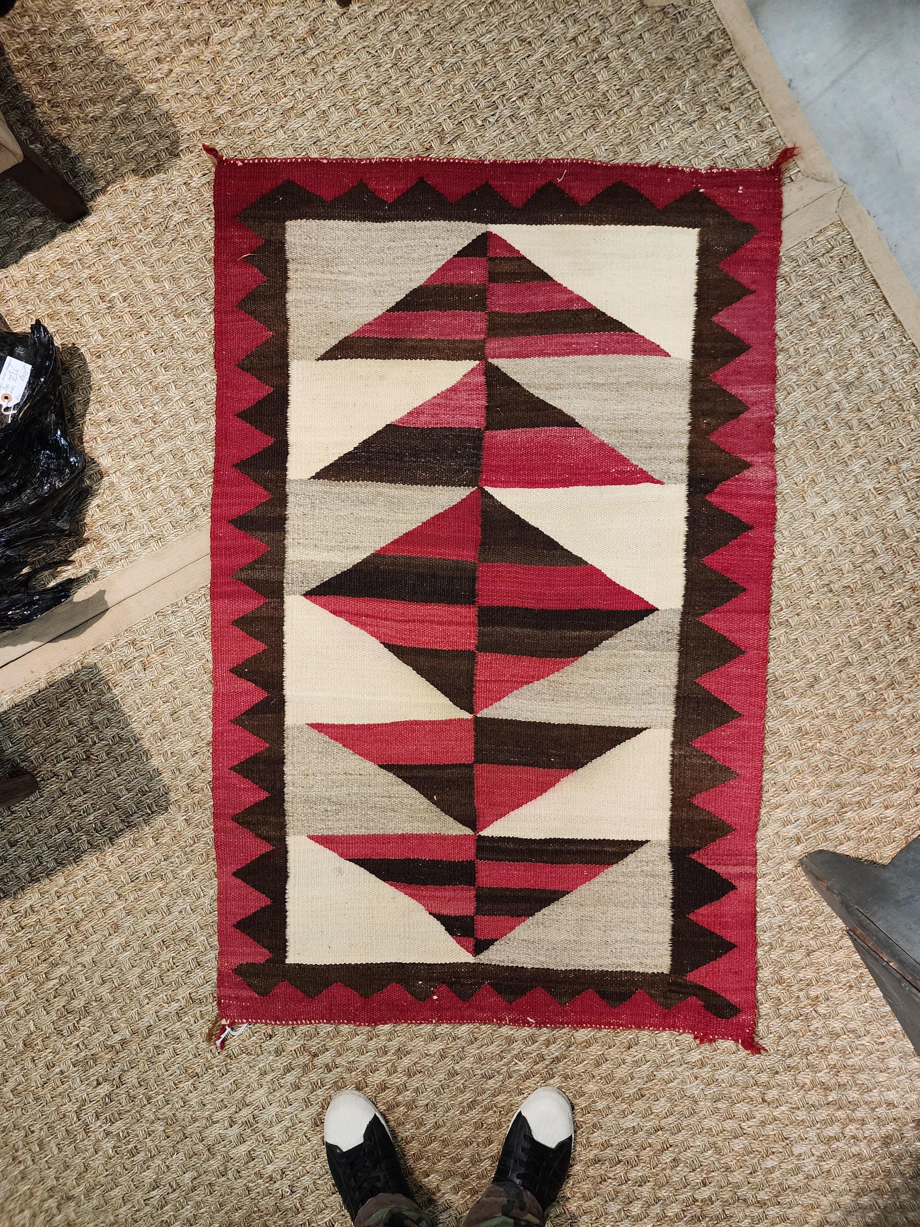 Circa 1890 Navajo weaving with a very elegant and modern design. Nice mottling of the natural colors, especially in the reds. This is a very bold weaving. This weaving is in good as found condition. Please examine all photographs and video carefully