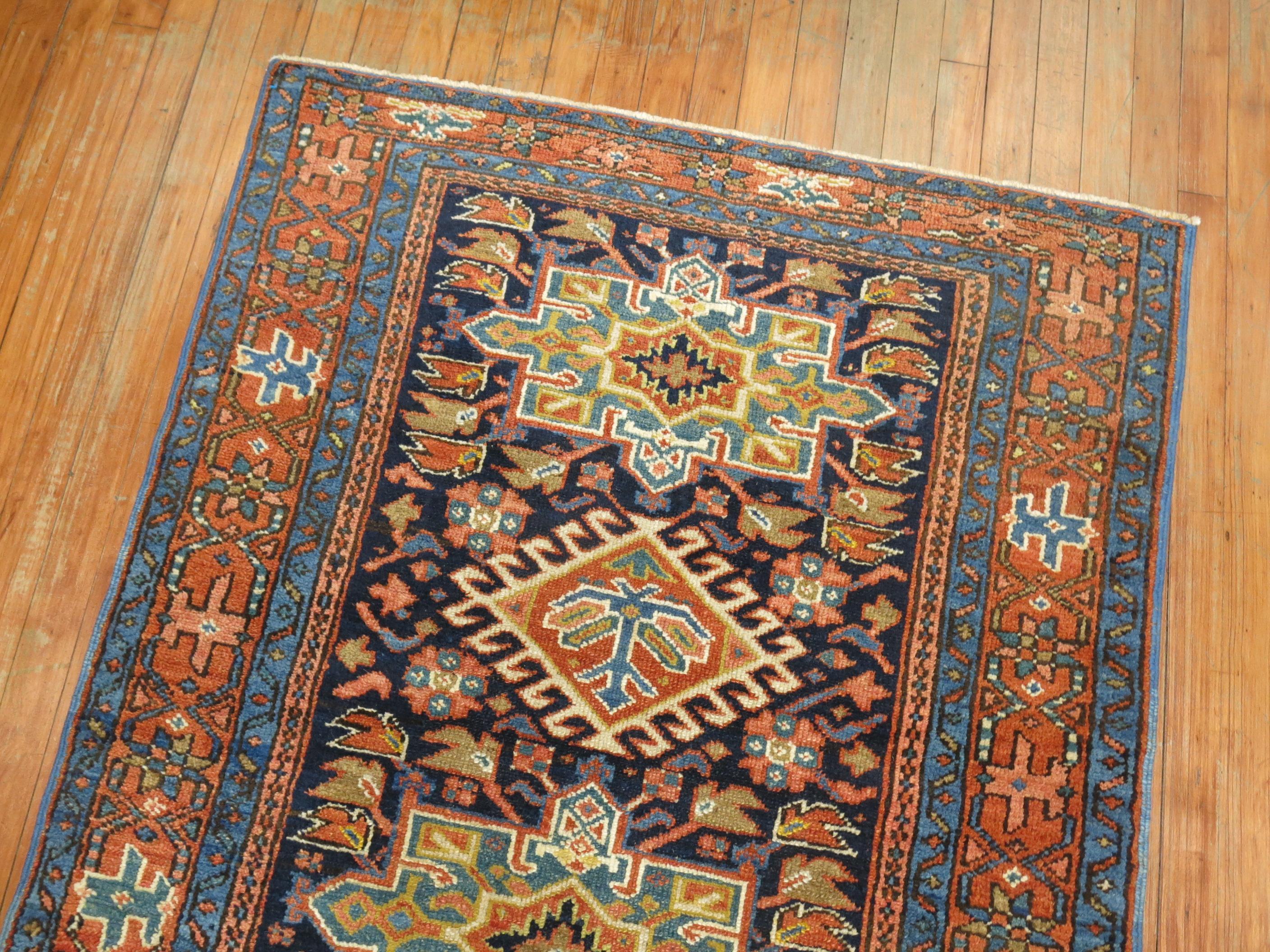 Colorful antique Persian Heriz Karadja rug with an all-over geometric motif on a navy blue ground.

3'6'' x 4'5''.