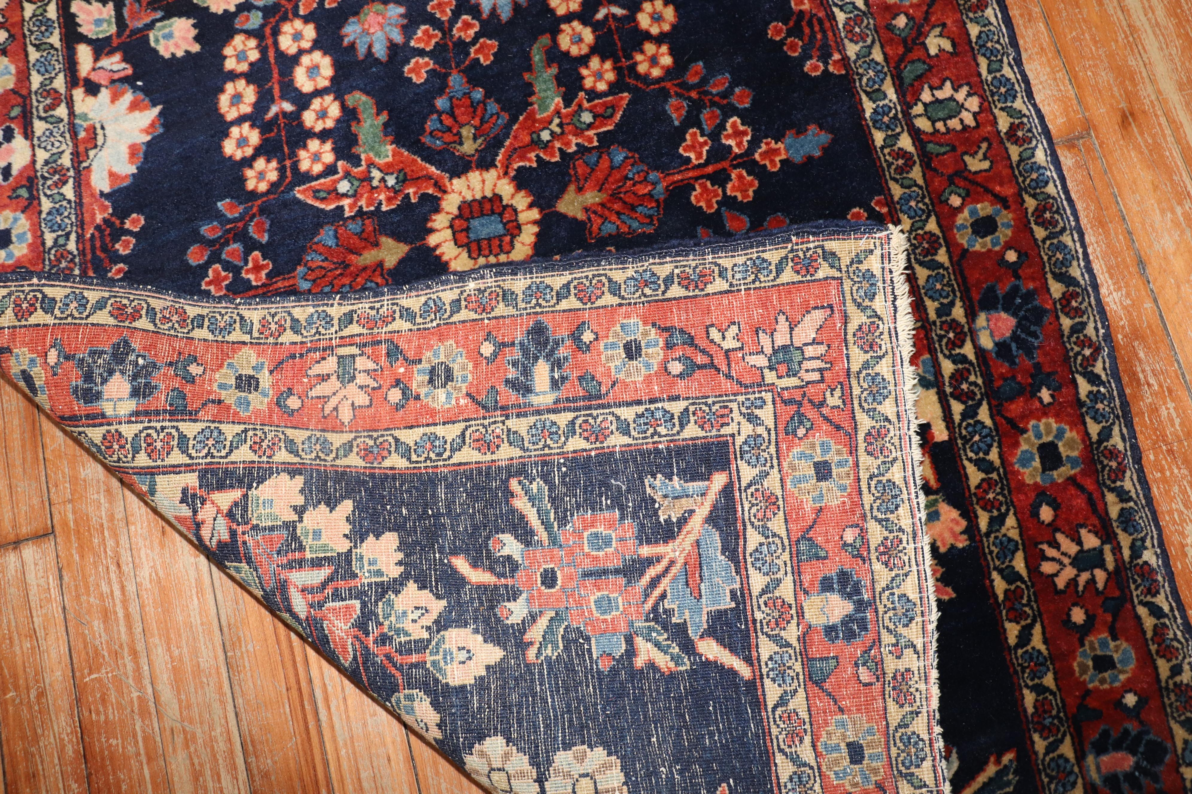An authentic early 20th-century scatter size Persian Sarouk carpet with Classic medallion and border design on a crisp navy blue field, circa 1910.

Measures: 2'9